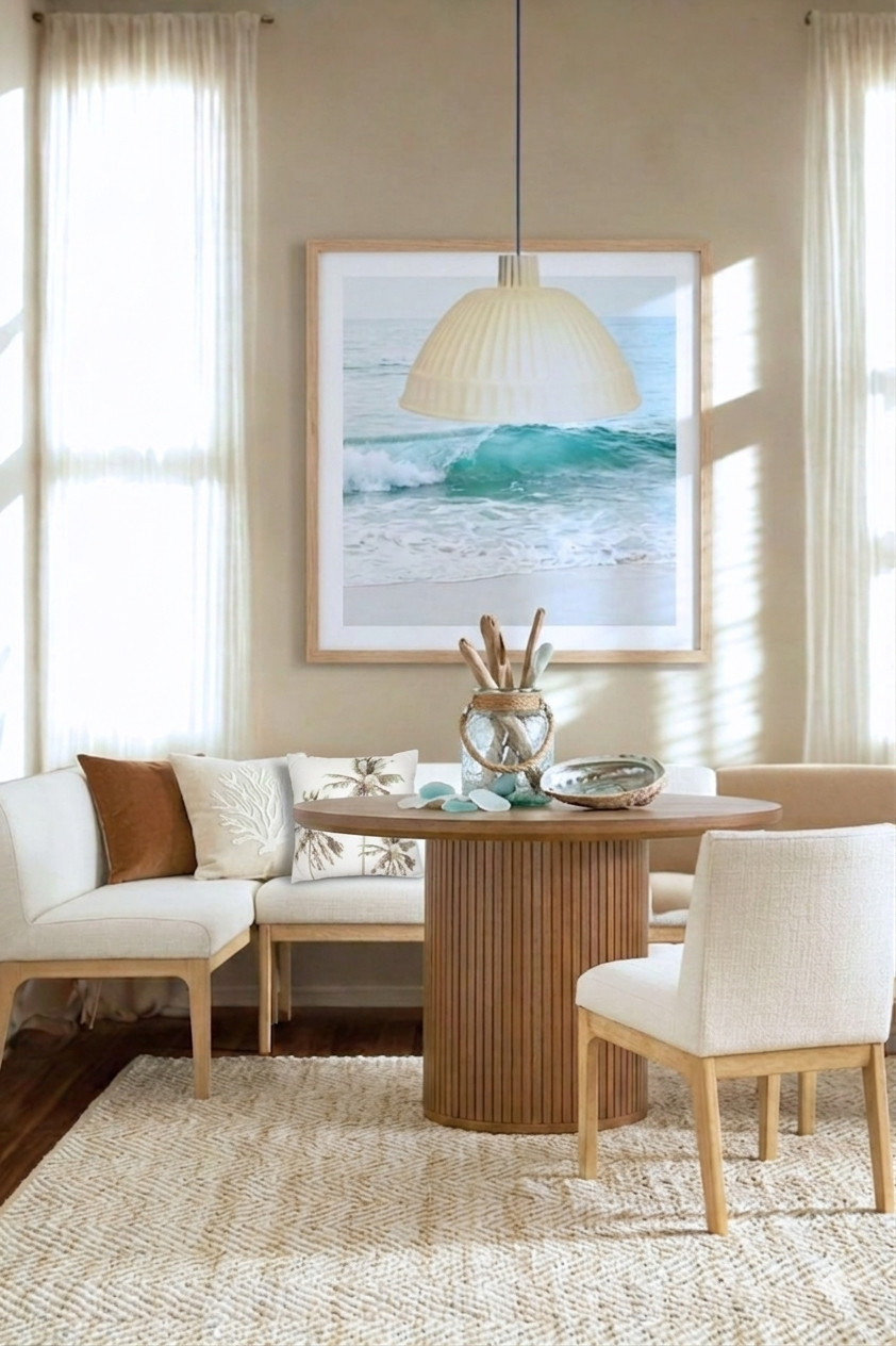 Looking for inspiration for a corner dining nook? The banquette dining seating and chair are neutral so you can accent style and color. An ocean painting adds a colorful coastal focal to the room. The accessories and rug finish off the beachy vibe nicely. 

 #banquetteseatingdiningroom #cornerdiningnook #coastalstyle #LTKHome