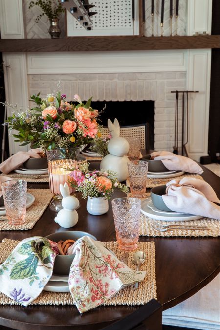 Easter table setting featuring floral print napkins, woven place mats, green bowls, colored glassware, bunnies, and a floral arrangement in a rattan wrapped vase

#LTKSeasonal #LTKfindsunder50 #LTKhome