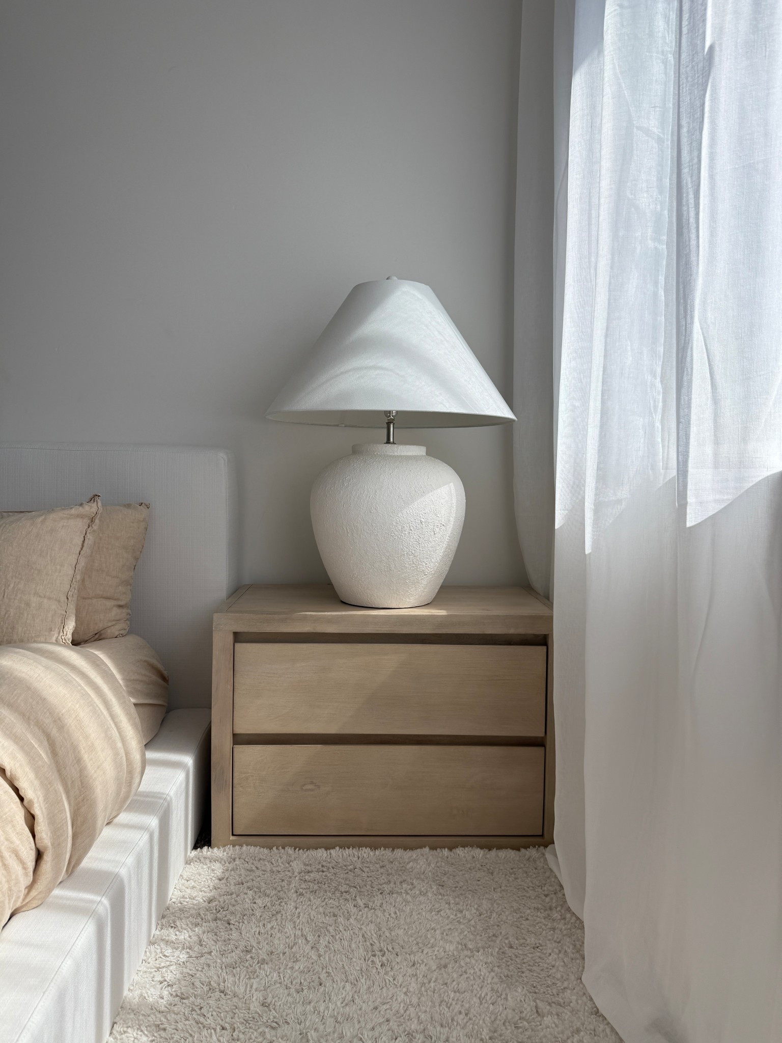 Favorite little corner! Cayman wide nightstand from Pottery Barn, soft frame bed, Brooklinen bedding, oversized ceramic lamp from Wayfair 

#LTKHome