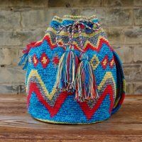 large multicoloured cross shoulder bucket bag, handmade by crochet in La Guijra Colombia by the Wayu | Etsy (US)