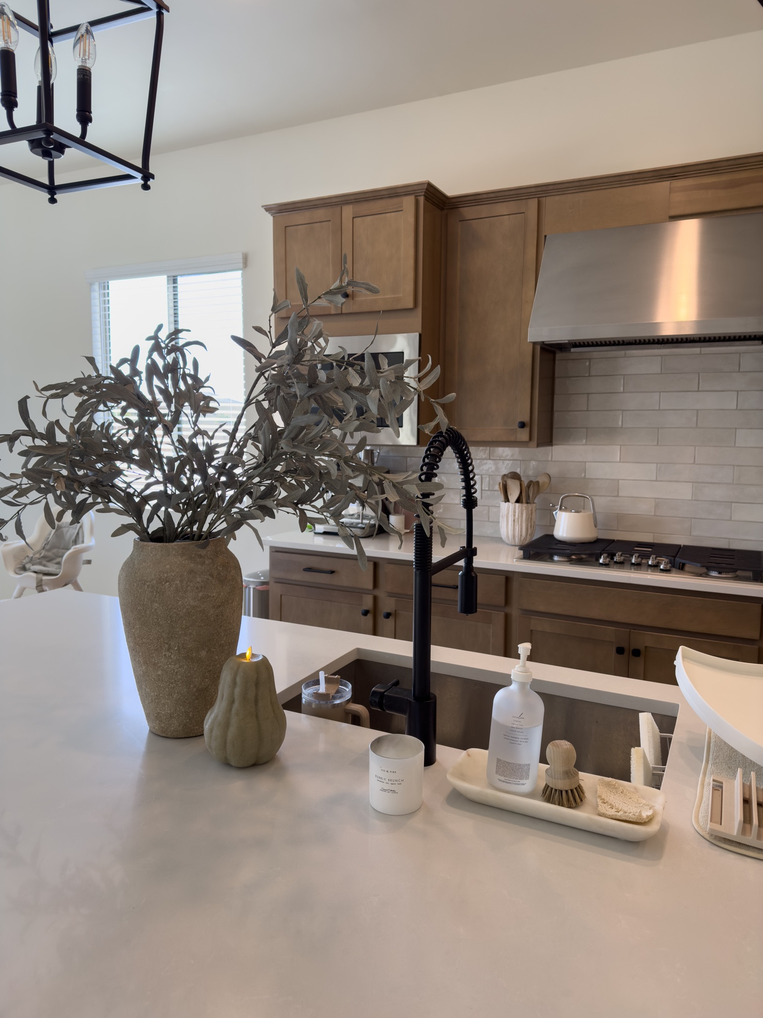 Terracotta vase with faux olive branches (I have 3 branches). Also linking this faux pumpkin candle on sale! 🤍 

#LTKhome