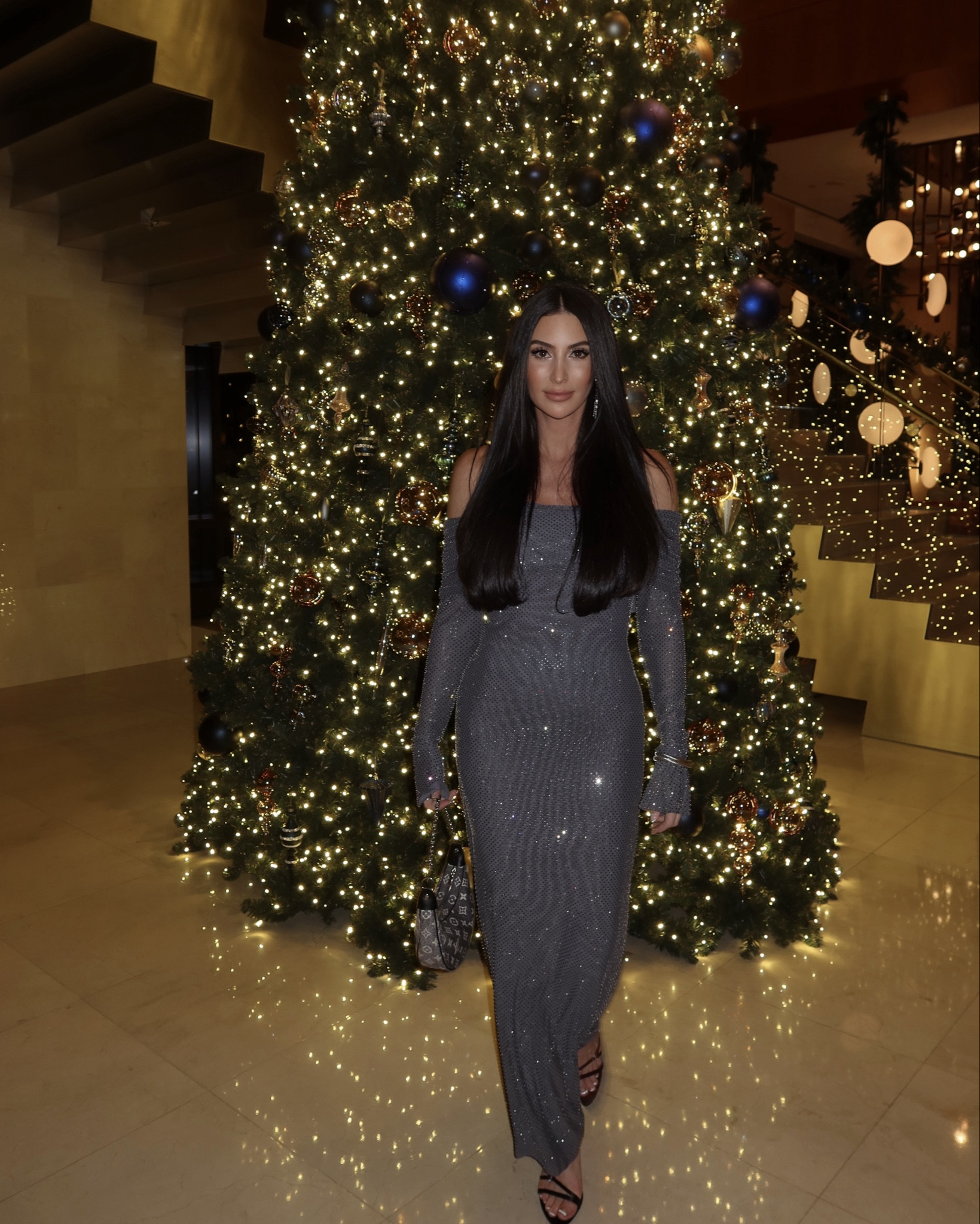 The MARCEL is a fitted maxi dress with a straight skirt and long sleeves. The off-shoulder neckline pairs perfectly with the fabric overlay over the bust, while the long sleeves have been designed to cinch to your arms before transitioning into flared hems around the wrist and palm. Adorned with rhinestones, MARCEL's stretchable material promises both comfort and shimmer. True to size, wearing size medium