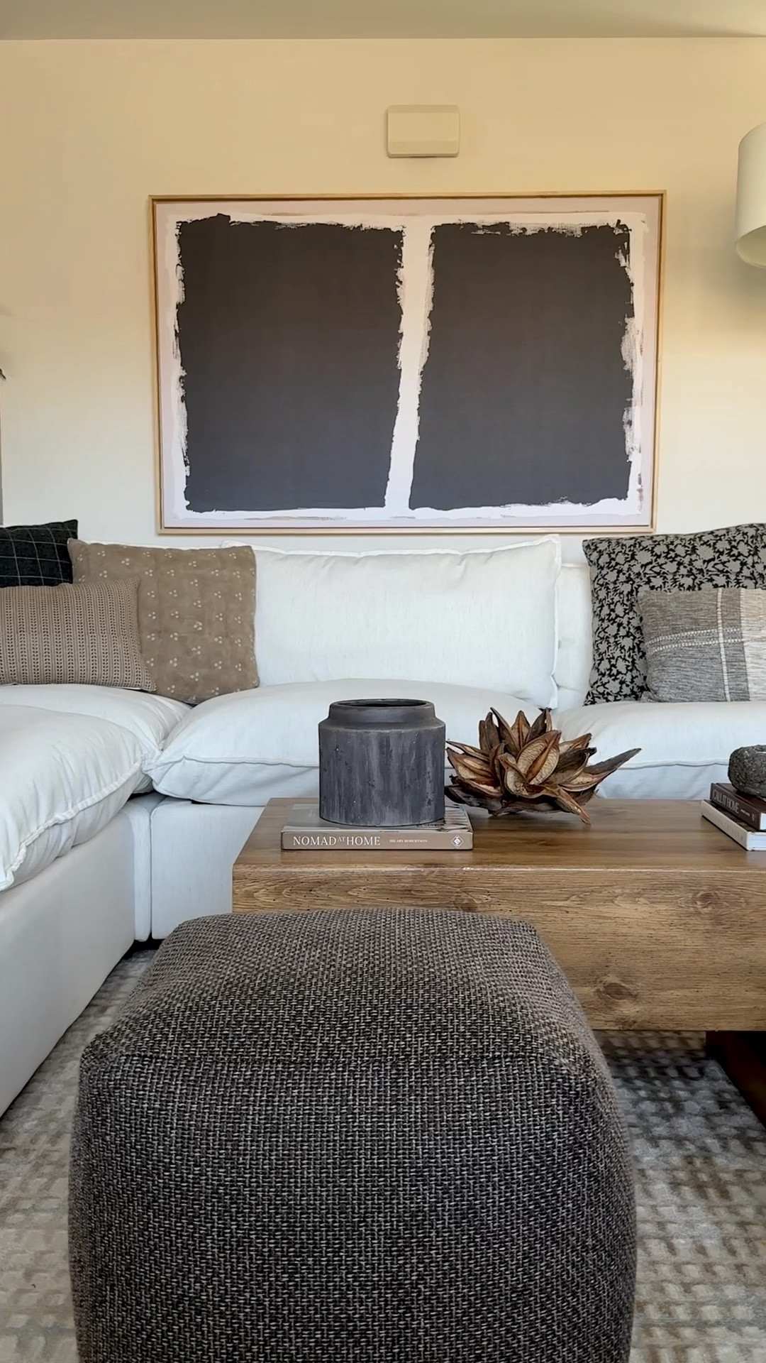 One year living room transformation 🤎 
Washable sectional, black and white modern artwork, brown poufs, coffee table decor, moody living roomm

#LTKHome #LTKWatchNow #LTKSaleAlert