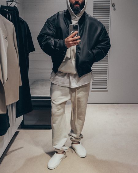 FEAR OF GOD Eternal Collection Shell Bomber Jacket in ‘Black’ (size L), Eternal Hoodie in ‘Cement’ (size M), Classic Cotton Jersey Sweatpants in ‘Cement’ and California slides in ‘Greige’ (size 41). A relaxed and elevated men’s look that’s layered and perfect for a casual Spring outing.

#LTKmens #LTKstyletip