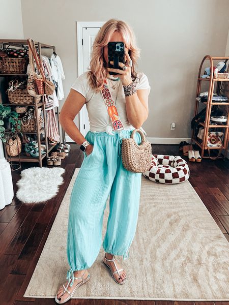 OOTD STYLE with gauze pj pants and the cutest white lettuce edge tee! 
•Pants M
•Tee S
•Metallic sandals TTS 
✨WATCHBAND save with code MANDIE
✨LONG NECKLACE save with code MANDIE15 

Straw bag, purse strap, free people, target finds, amazon finds, Sparkl band, twisted silver necklace 

#LTKStyleTip #LTKOver40 #LTKFindsUnder50
