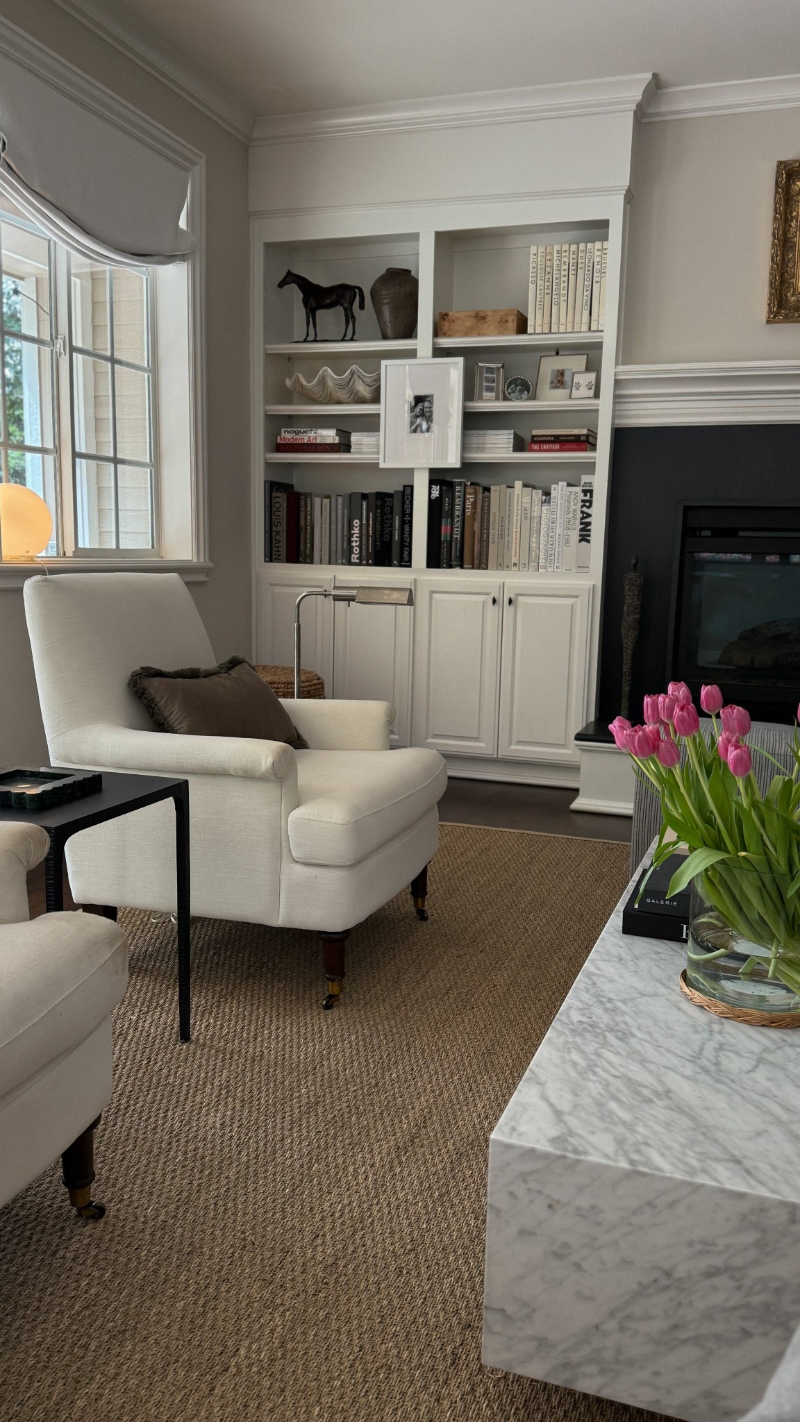 Seagrass rug, roll arm chair, studio McGee, pottery barn, built in shelf inspo, book shelf, picture frames 

#LTKHome