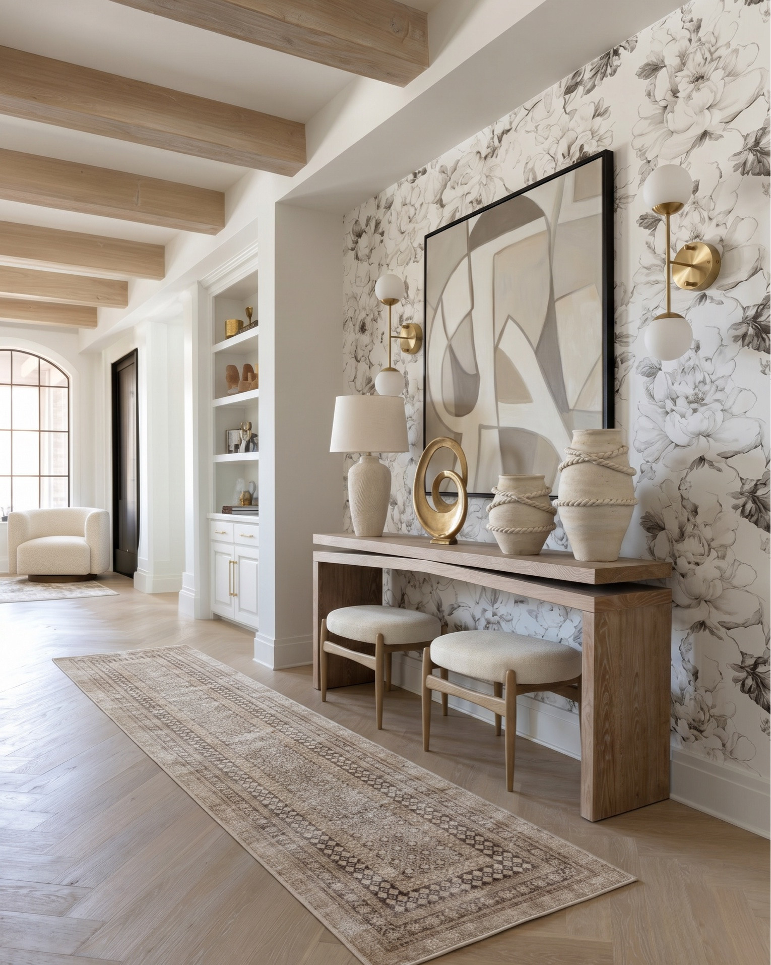 Shop the look:
• Fluted cream built-in cabinetry
• Brass cabinet hardware (pulls + knobs)
• Glass-front upper cabinet doors (reeded / ribbed glass)
• Brass dual globe wall sconces (white milk glass)
• Built-in wine fridge (glass door, brass trim)
• Espresso machine / built-in coffee station
• Decorative ceramic face sculpture
• Neutral ceramic bowls
• White ceramic pitcher
• Amber glass bottles
• Framed vintage artwork
• Decorative wood tray
• Brass bowl / catchall
• Sculptural woven vase
• Neutral decorative books
• Large woven or textured runner rug (taupe / beige)
• Light oak ceiling beams
• Light wood console table (minimal modern design)
• Upholstered round stools / vanity stools
• Neutral floral wallpaper (large-scale botanical print)
• Oversized abstract wall art (black frame)
• Brass double globe sconces
• Ceramic table lamp (neutral textured base)
• Gold sculptural ring decor
• Large rope detail ceramic vases
• Vintage-inspired neutral hallway runner
• Decorative wood bowls
• Ceramic decor accents
• Cream boucle accent chair
• Arched black-framed window
• Light gray upholstered wingback bed
• White bedding set (duvet + sheets)
• Chunky knit throw blanket (cream)
• Neutral accent pillows (textured + patterned)
• Upholstered bedroom bench (cream with brass legs)
• Light wood nightstands (3-drawer)
• Pleated table lamp (neutral ceramic base)
• Large glass vase with greenery / dried florals
• Ornate gold full-length mirrors
• Brass double globe wall sconces
• Large abstract artwork above bed
• White globe pendant light
• Vintage-inspired area rug (gray / beige)
• Light wood ceiling beams
• Soft linen curtains (cream)
• Herringbone hardwood flooring
• Small ceramic vase with dried florals
• Decorative bedside styling
• Neutral ceramic lamp
• Gold framed mirrors
• Minimal layered pillows
• Luxury hotel-style white duvet

#LTKsale #LTKhome