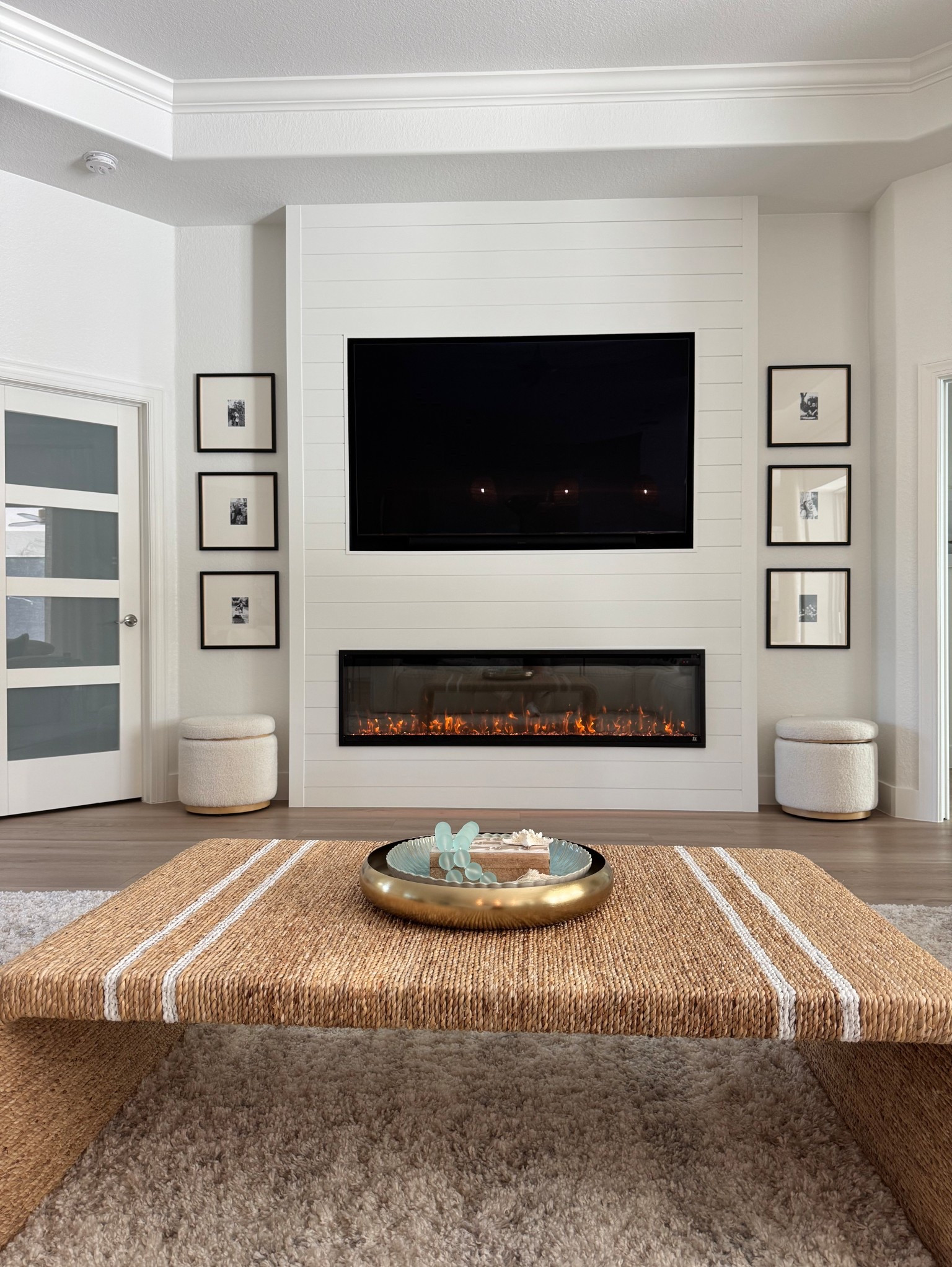 Shiplap tv wall with black gallery frames and linear fireplace cute storage ottomans finish the space. 

#LTKStyleTip #LTKFamily #LTKHome