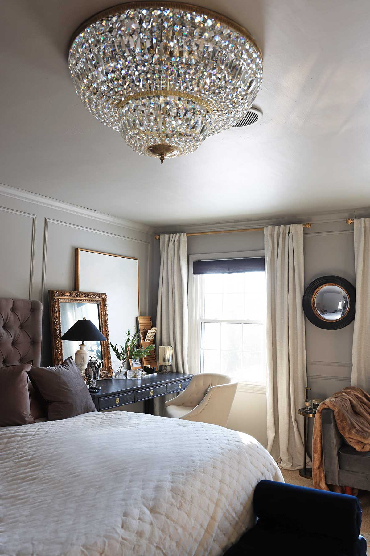 Bedroom styling | Gorgeous oversized flush-mount chandelier | Round mirror | Navy desk | Brown throw pillow covers 

 #LTKHome