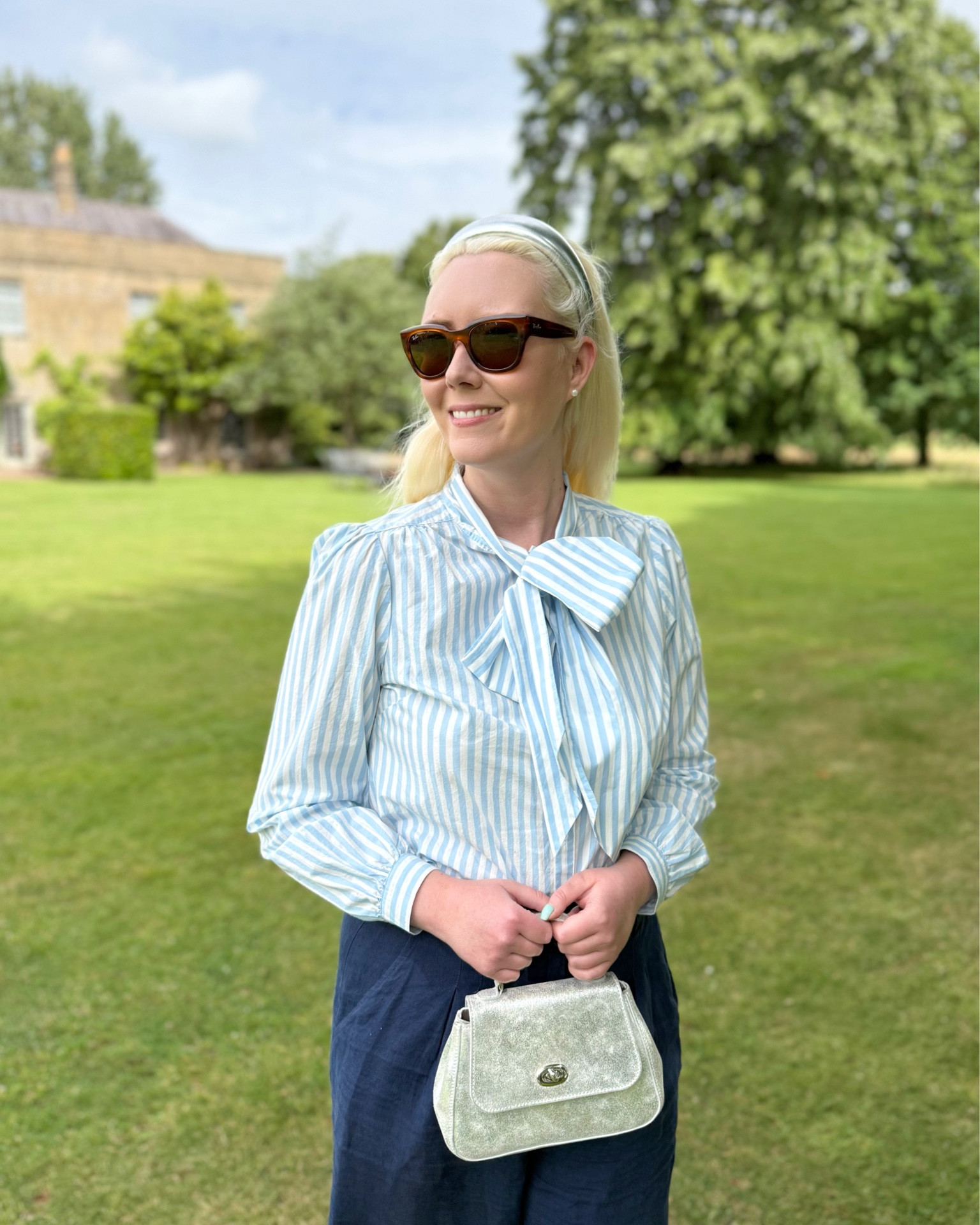 Nautical vibes are a huge trend this summer but you don’t have to opt for a sailor collar if you want your outfit to be a little more subtle. 

I partnered this pale blue & white stripe pussy bow blouse with navy linen wide leg trousers, while the silver shoes, handbag & headband are what elevates this look into something memorable, taking you  from the office to a dinner date. 

The finishing touch are some timeless sunglasses and a pair of freshwater pearl stud earrings. See the product list for similar pieces currently in stock 💙 ⚓️💙

Details:

Bow blouse - Boden 
Linen trousers - Brora
Silver Mini Holly Bag - Tusting
Sunglasses - Rayban 
Pearl Earrings - Dower and Hall

#LTKsale #LTKbag #LTKshoes #LTKeurope #LTKsummer #LTKstyletip #LTKuk