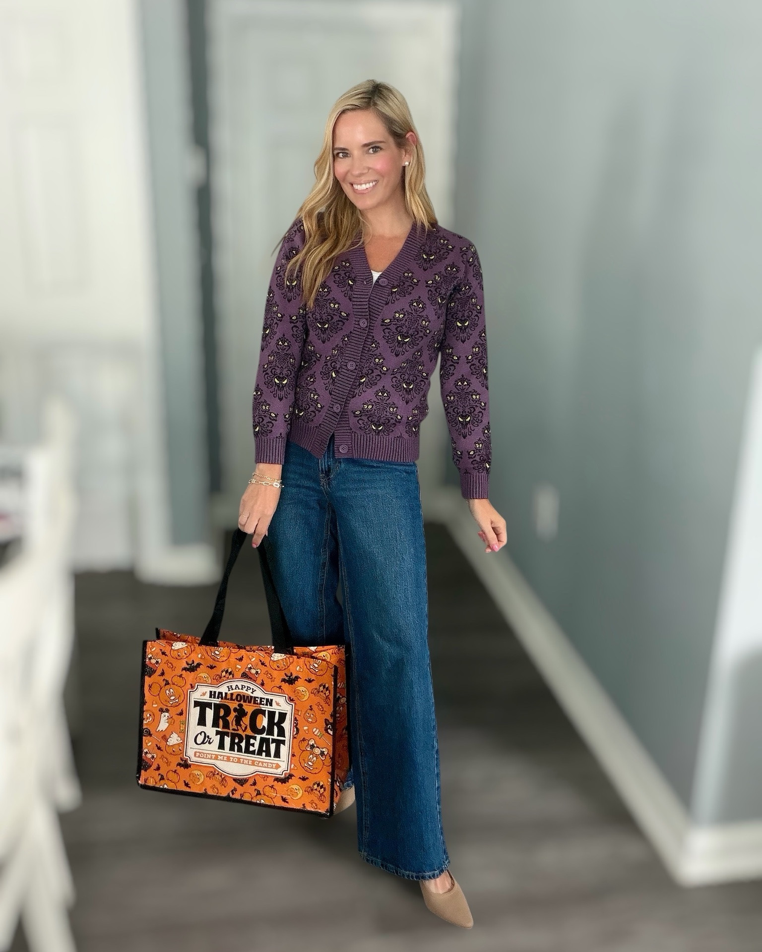 Disney Haunted Mansion Cardigan Outfit 🖤💜👻

Calling all Disney Halloween fans! This Haunted Mansion cardigan is even cuter in person and such a fun way to add a little spooky magic to your fall wardrobe. I paired it with wide-leg jeans, neutral kitten heels, and a festive Disney Halloween tote for an easy outfit that’s perfect for the parks, Mickey’s Not-So-Scary Halloween Party, or everyday fall fun. 🎃✨

I’m wearing the kids size 9/10 in the cardigan for a fitted look. Everything else is linked, including the jeans, heels, tank, bracelets, and Halloween tote! 🖤🍂

Disney Halloween outfit, Haunted Mansion cardigan, Disney style, Mickey’s Not-So-Scary Halloween Party outfit, Disney fall fashion, spooky season outfit, pumpkin season style, wide leg jeans, neutral kitten heels, Halloween tote bag, casual fall outfit, Disney fan outfit, family Disney trip style.

#LTKOver40 #LTKPetite #LTKKids