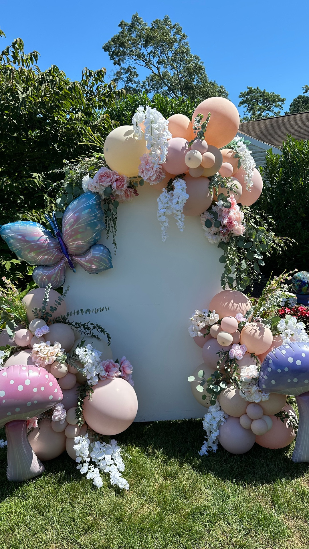 Fairy First Birthday balloon arch for photo opportunity. White backdrop wall with mauve balloons and mushroom & butterfly additional baloons and artificial flowers


#LTKParties #LTKKids #LTKBaby