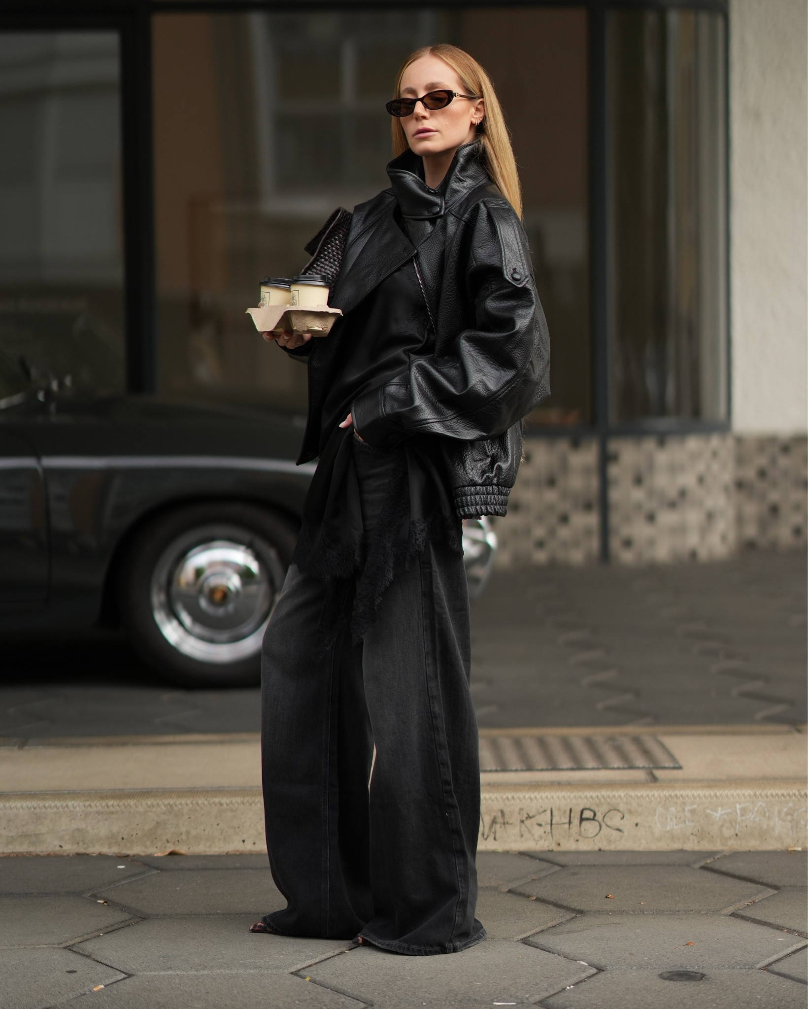 autumn streetstyle • wearing black oversized denim pants, a black silk lace top and an oversized leather jacket - Accessoires: a woven brown bag and Leo heels #autumn #autumnoutfit #lacetop #lace 

#LTKstyletip #LTKeurope #LTKdeutschland