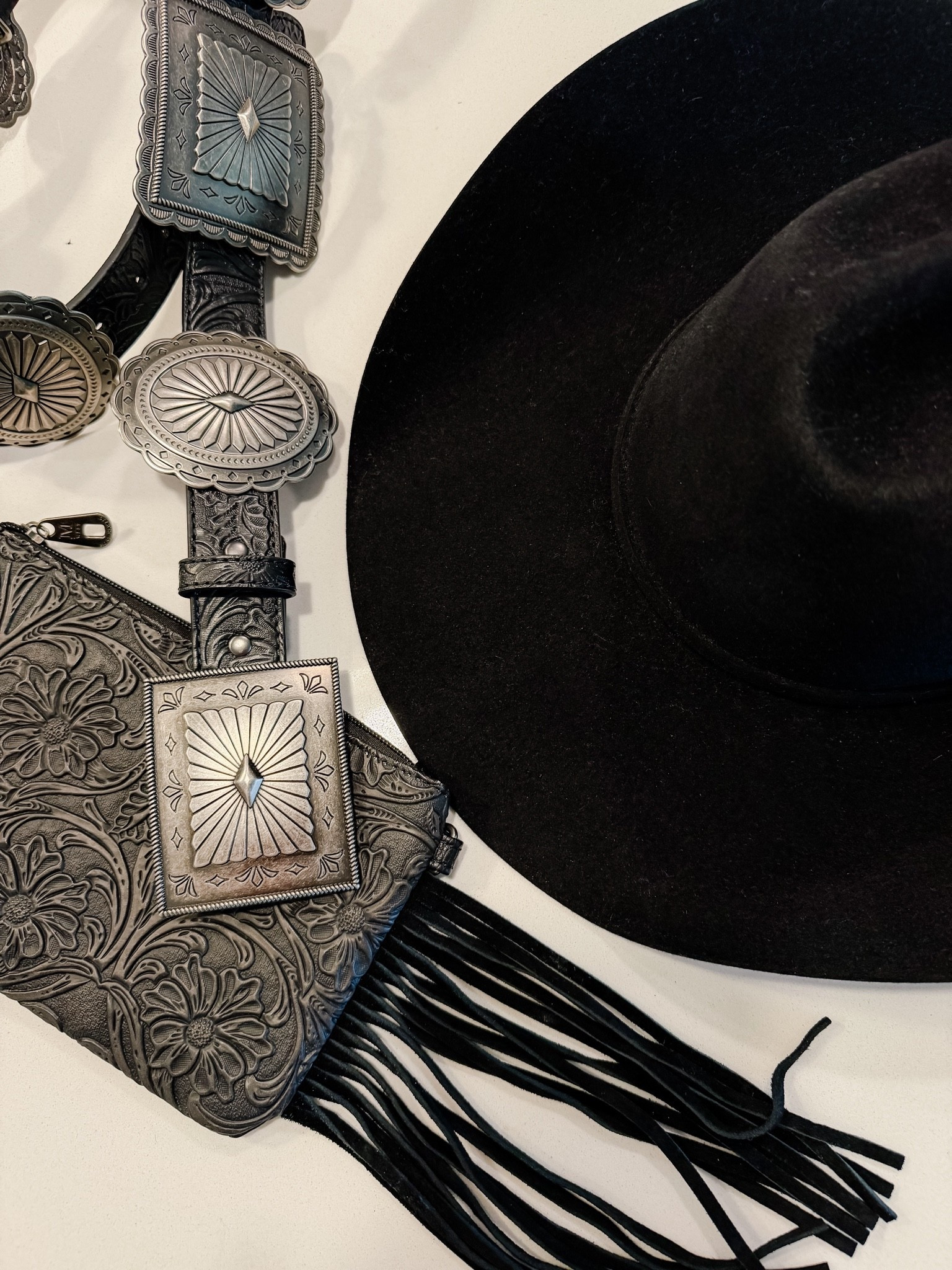 Must have western accessories - a good Concho belt, a cowboy felt black hat and a fringe wristlet purse

#LTKgrwm #LTKootd