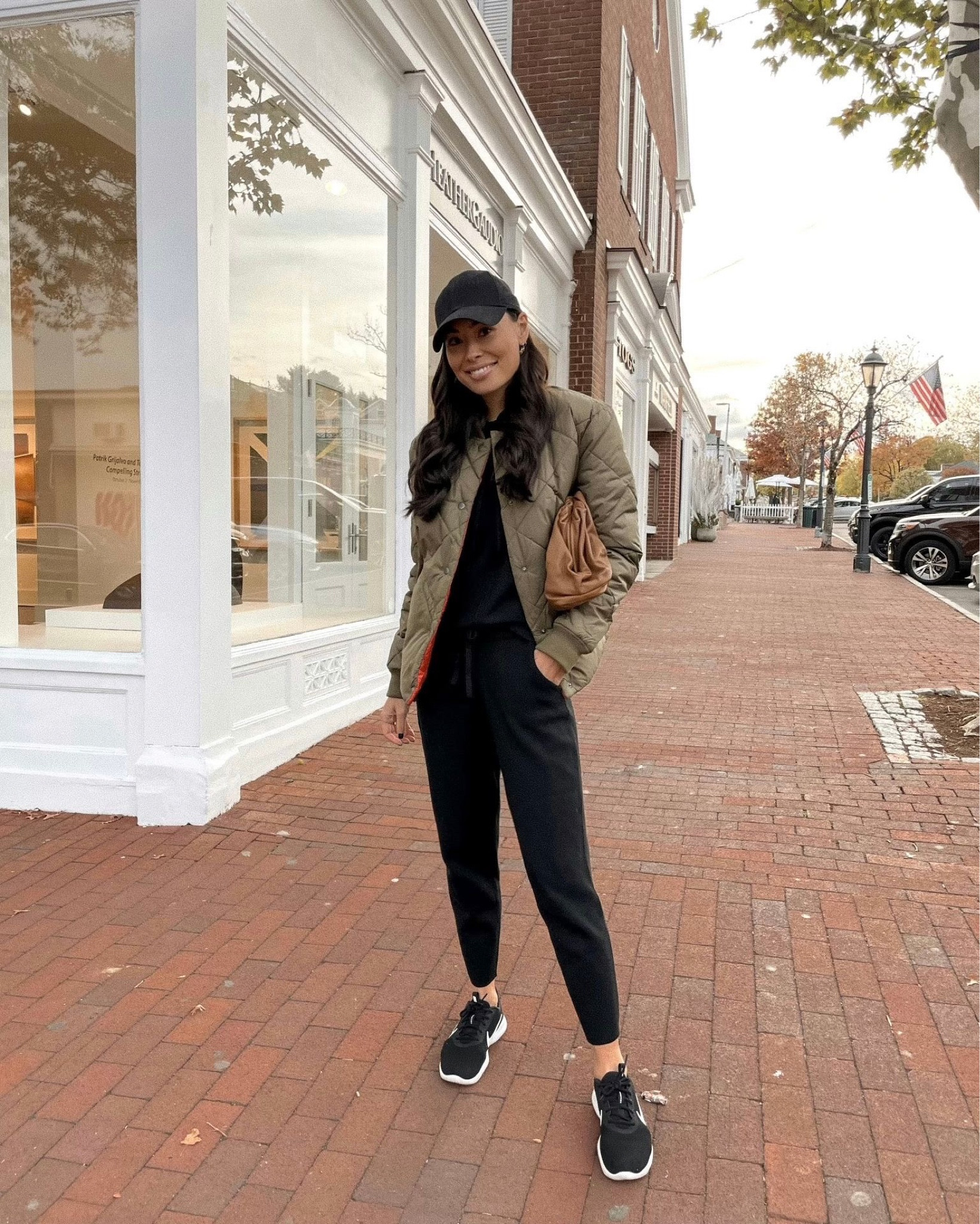 Kat Jamieson of With Love From Kat wears a fall outfit. Black sweatpants, black hat, olive jacket, fall style, black sneakers, black sweatshirt, neutral style. 

#LTKstyletip #LTKSeasonal