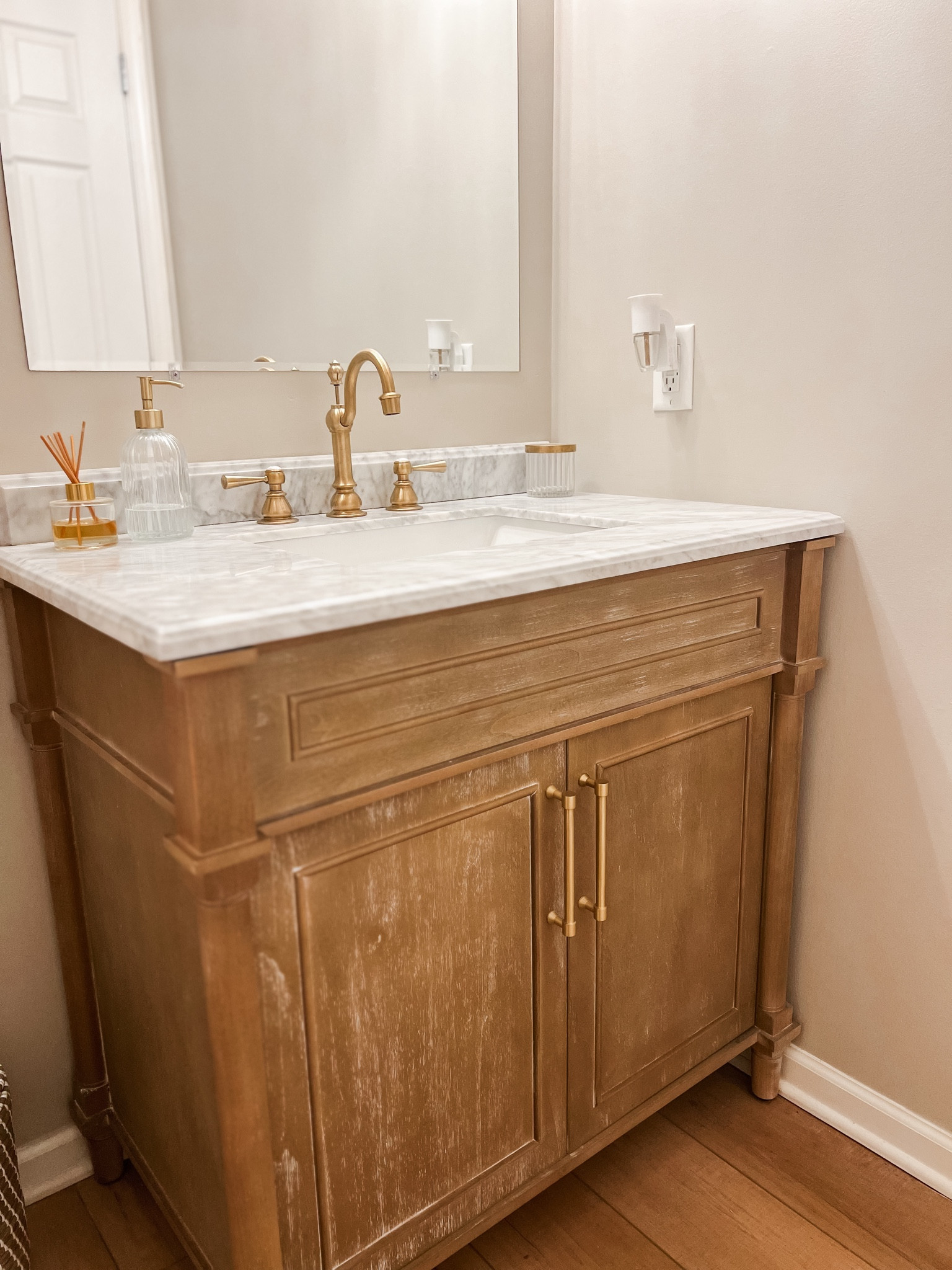 Affordable bathroom vanity for powder room. Neutral vanity. Marble top vanity. Brass fixtures  

#LTKhome