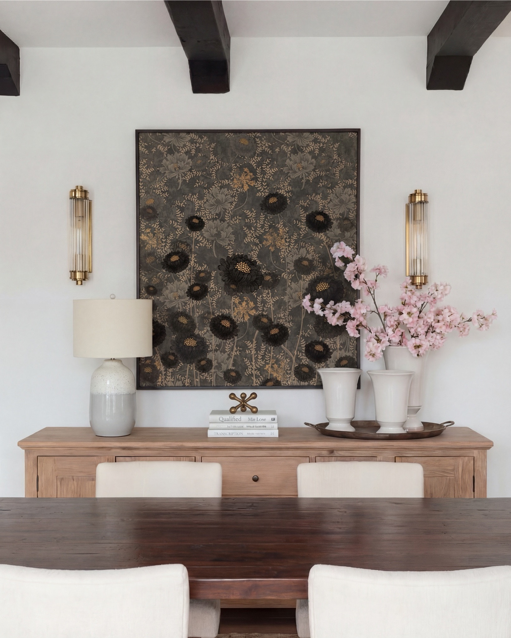 Shop the Look:
• Dark wood pedestal dining table
• Cream upholstered dining chairs with light wood legs
• Large neutral area rug with charcoal medallion pattern
• Black arched display cabinet / hutch
• Light wood sideboard / buffet cabinet
• Large ceramic floor vase (neutral tone)
• White ceramic bowl with white florals (peonies or roses)
• Pink faux cherry blossom stems in white vase
• Neutral ceramic table lamp with white shade
• Tall brass wall sconces with glass detailing
• Framed botanical artwork (set of four)
• Dark abstract wall art (large statement piece)
• White decorative vases (assorted sizes)
• Light linen curtains

#LTKSaleAlert

#LTKsale #LTKhome