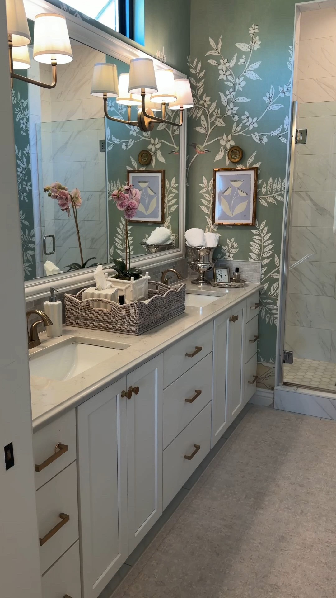 From vanities to lighting, Wayfair makes bathroom upgrades easy and affordable ! 

#WayfairPartner #ad #Wayfair @Wayfair This space came together with my favorite Grandmillennial details — layered chinoiserie wallpaper, warm brass fixtures, woven textures, and classic blue & white accents that make the bathroom feel collected, cozy, and timeless. Sharing all the pieces that elevated this refresh without a full renovation ✨

PRODUCTS LINKED• Chinoiserie botanical wallpaper• Brass vanity faucet• Triple arm brass vanity sconce with fabric shades• White framed wall mirror• Brass cabinet hardware pulls• Marble look quartz vanity top + undermount sink• White scalloped ceramic accessories set (soap dispenser, tray, dish)• Silver ice bucket towel holder• Wicker vanity tray organizer• White ceramic orchid planter + orchid stem• Small round decorative wall art frames• Bamboo picture frames botanical prints• Decorative tray with perfume + clock styling• Subway mosaic backsplash tules

#ltkhome #ltkstyle #ltkfinds #bathroomrefresh #powderroomdecor #grandmillennialstyle #traditionalhome #chinoiseriedecor #classicinteriors #timelessdesign #bathroomdecor #interiordetails #cozyhome #collectedhome #southernstylehome #homeinspo #interiorstyling #vintagestylehome #blueandwhitedecor #brassfixtures #traditionalbathroom 

#LTKHome