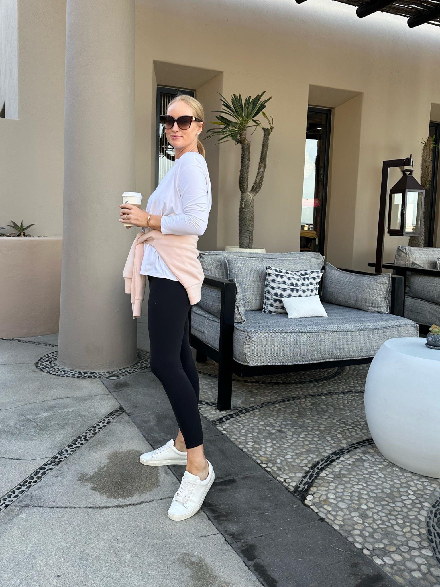 Comfy travel outfit for the flight back home! Wearing my favorite white sneakers, the most comfortable leggings, and layers because I get cold! 