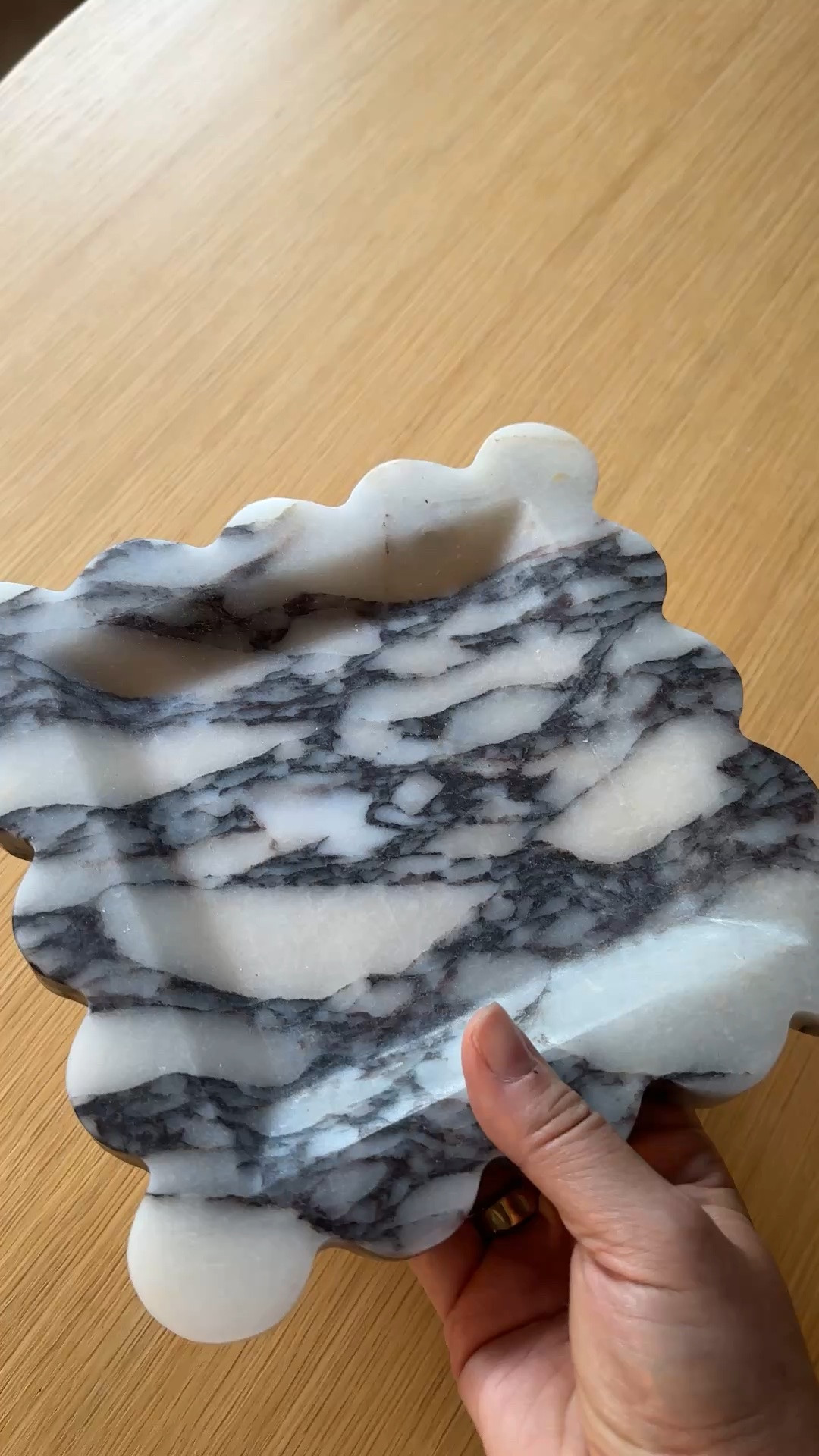 Here’s an LTK caption that fits your home decor niche:

One of those pieces that instantly makes a space feel more collected. This Calcutta Viola scalloped marble tray from Alice Lane Home is as functional as it is beautiful. Style it on a coffee table, kitchen island, bathroom vanity, or dresser to elevate everyday essentials. The rich veining and scalloped edge make it feel like a true statement piece.