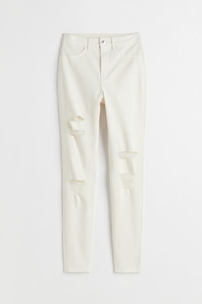 Fitted, ankle-length jeans in cotton denim with heavily distressed details. High waist to emphasi... | H&M (US + CA)