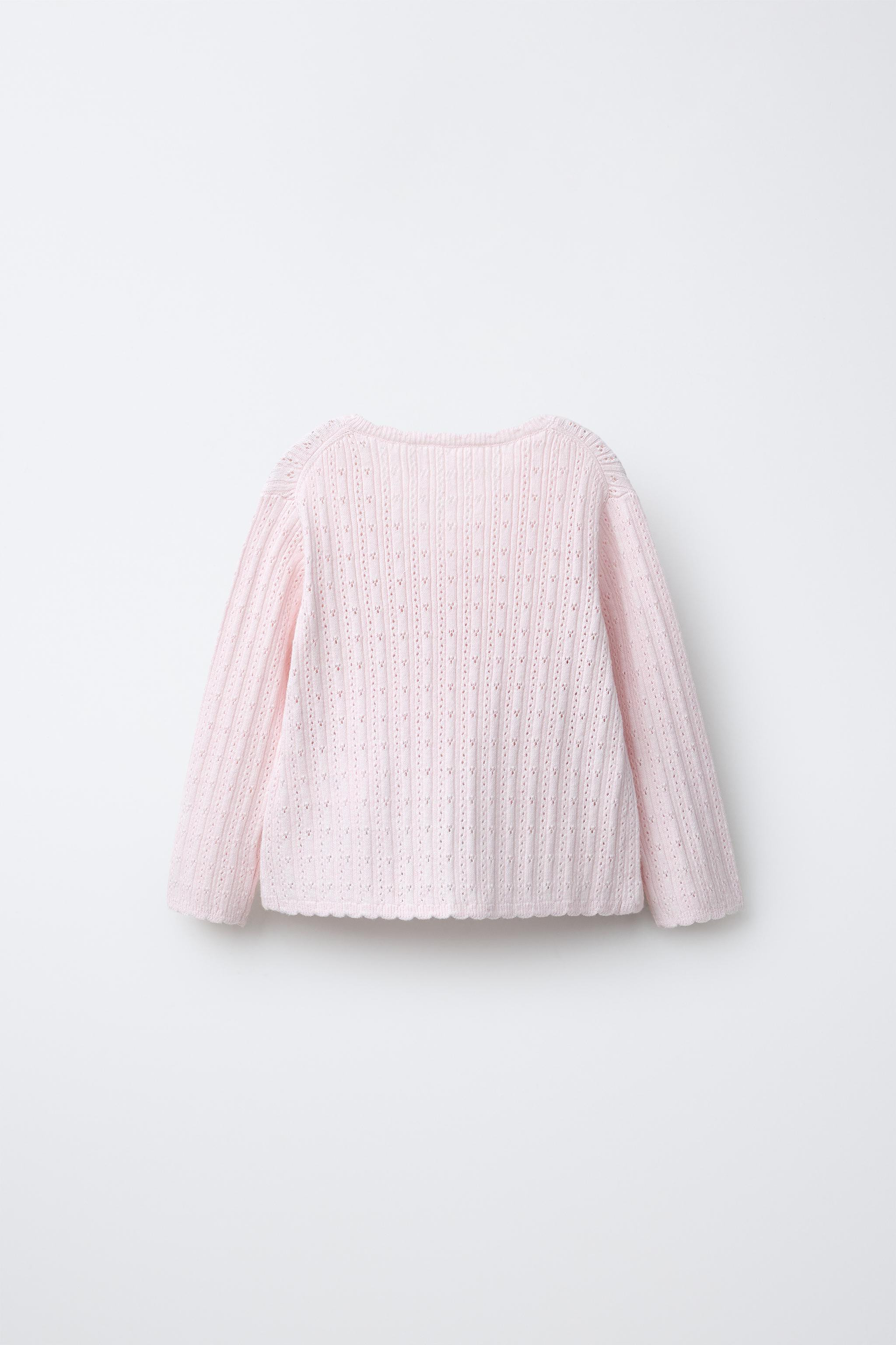 Openwork knit jumper with V-neck and long sleeves. Wrap-around button closure and interior button... | Zara US