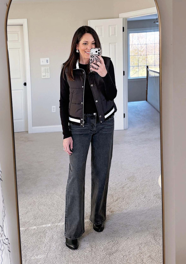  Relaxed straight leg jeans in an off-black wash are an easy way to update a puffer vest outfit  

 