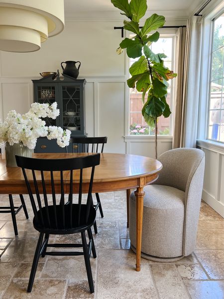 Dining Room with vintage table and cabinet, and modern upholstered swivel chairs and light fixture.

#LTKhome #LTKFind #LTKSeasonal