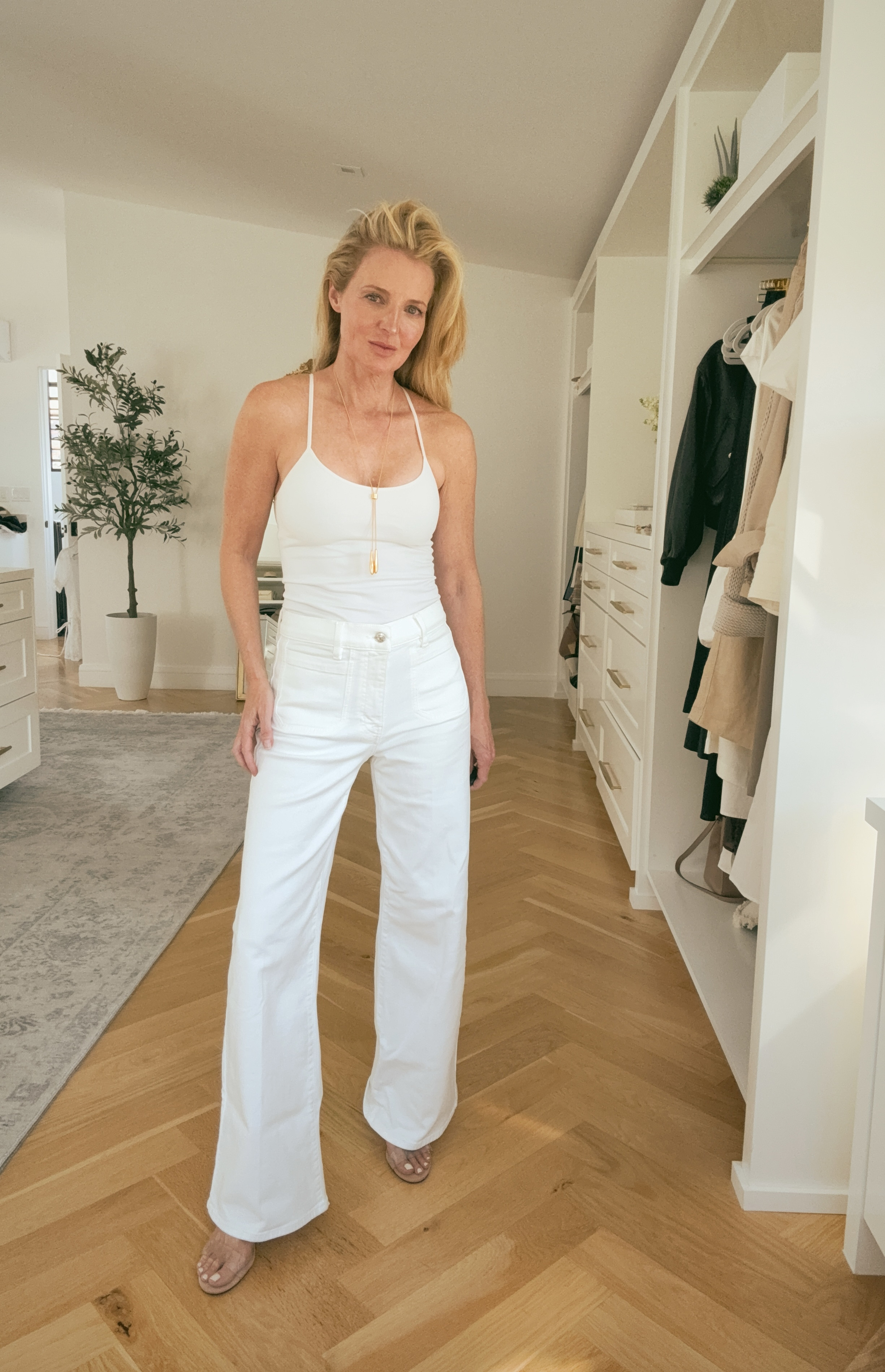 The patch pocket detail on the FRAME Le Slim Palazzo white wide leg jeans is the small thing that makes a big difference; it adds a design element to an otherwise clean silhouette and sits perfectly at the high waist. 

Monochromatic white with a white halter tank and nude sandals keeps the long line completely unbroken.

#LTKgrwm #LTKOver40 #LTKSaleAlert