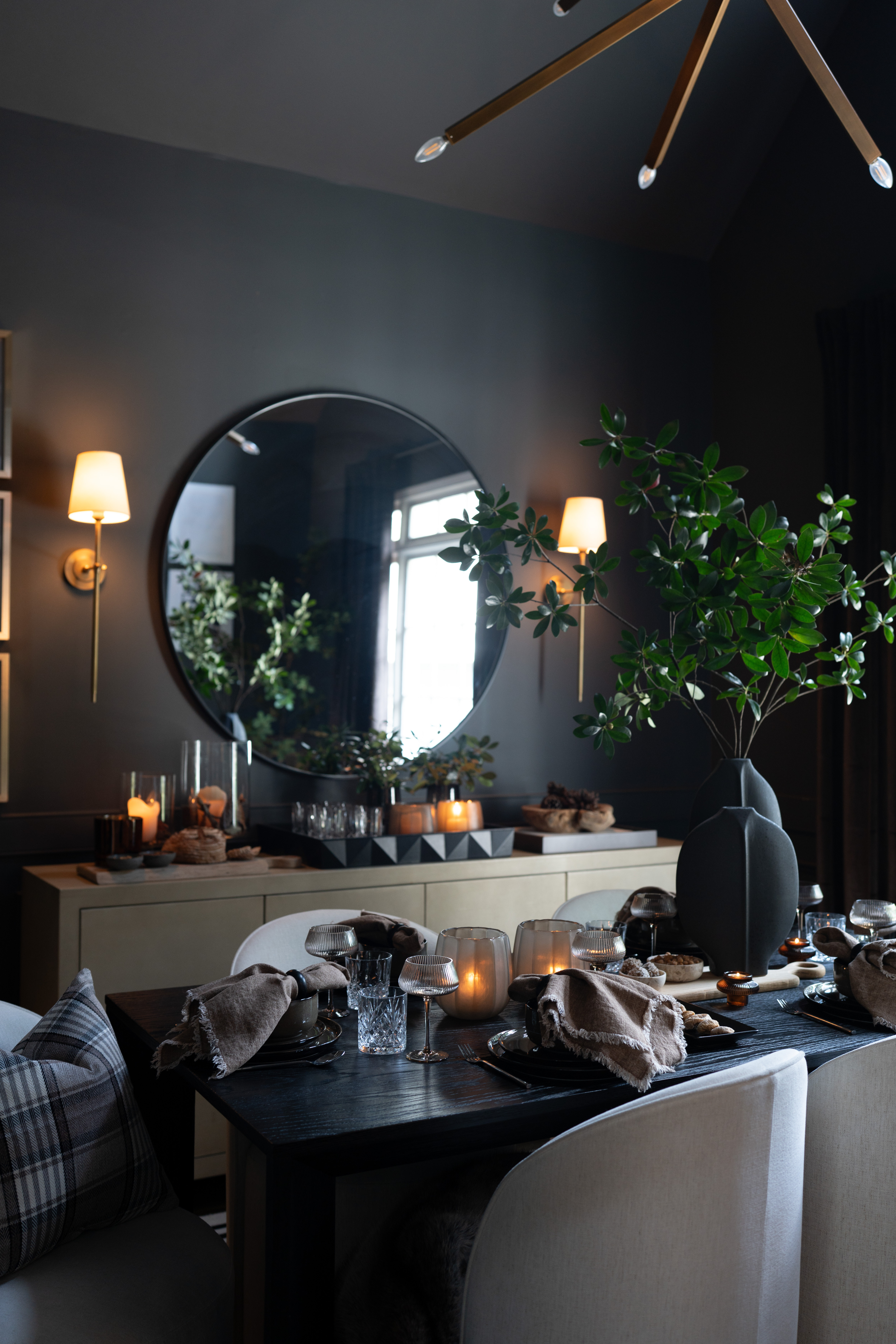 Moody, modern, and masterfully layered—this dining room blends soft candlelight with sculptural greens and rich textures. The dramatic black table grounds the space while warm gold tones and natural elements invite intimacy. Every detail, from the velvet napkins to the organic centerpiece, whispers elegance. It’s fall entertaining redefined—effortlessly refined and perfectly cozy for gathering. Cheers to the perfect night in!  

 #LTKSeasonal #LTKHome #LTKStyleTip