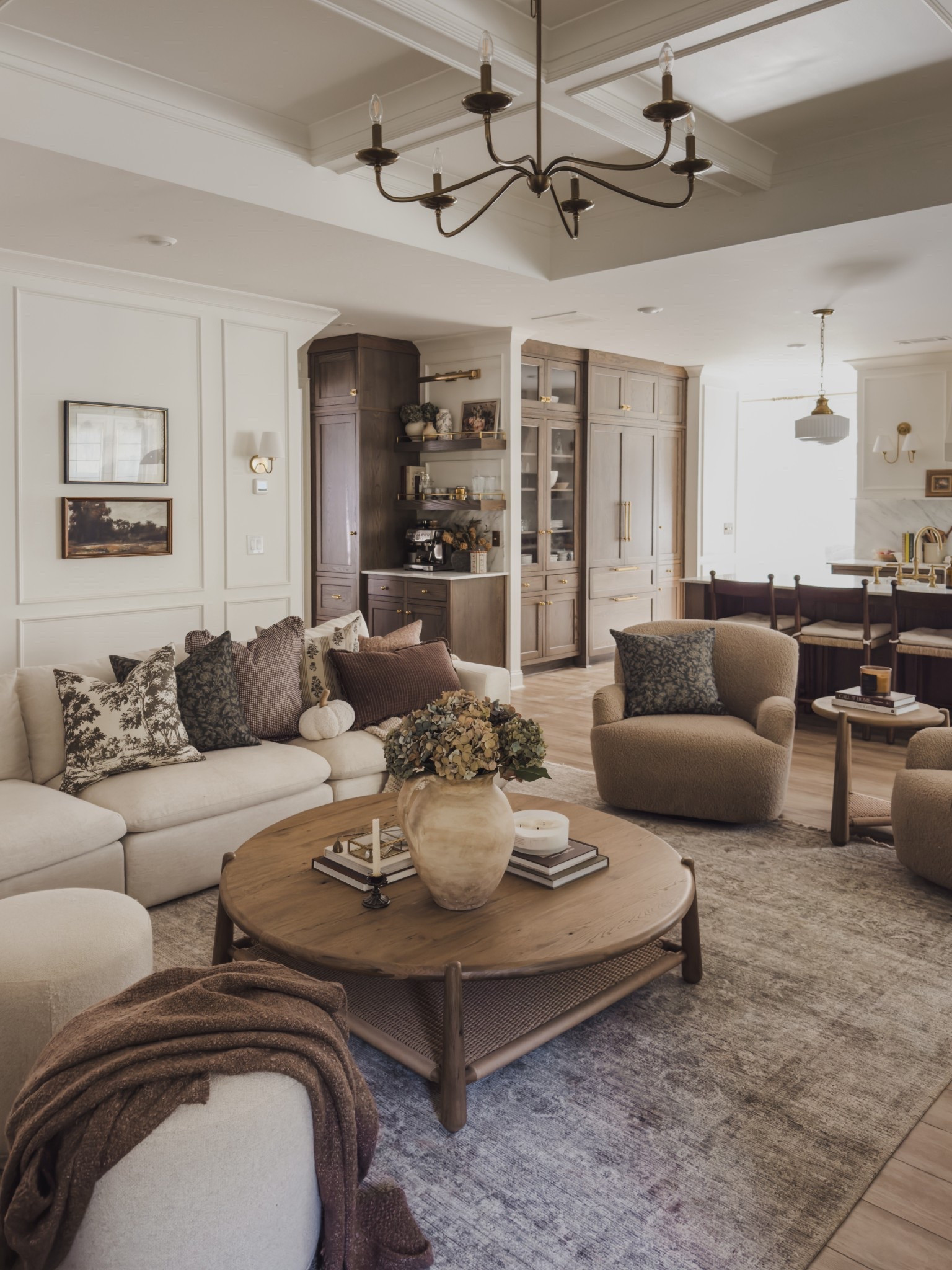 Cozy fall living room details! A combination of cozy throw pillows, seasonal florals, and all the collected vibes for a fall refresh. 

Home finds, neutral home inspo, cozy living room details, neutral wood tones, round coffee table, swivel accent chair, ottoman faves, accent revel, sectional details, open concept living room, cozy throw pillow, fall florals, collected style, gallery wall, chandelier details, Wayfair, Four Hands, Pottery Barn style, Loloi, Woven Nook, shop the look'

#LTKSeasonal #LTKHome #LTKStyleTip