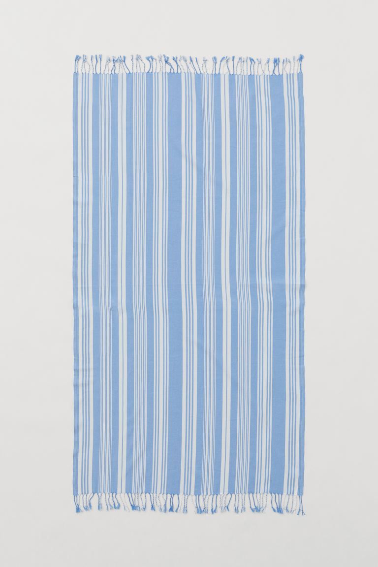 lemlem x H&M. Striped beach towel in woven organic cotton fabric with long fringe at short sides.... | H&M (US + CA)