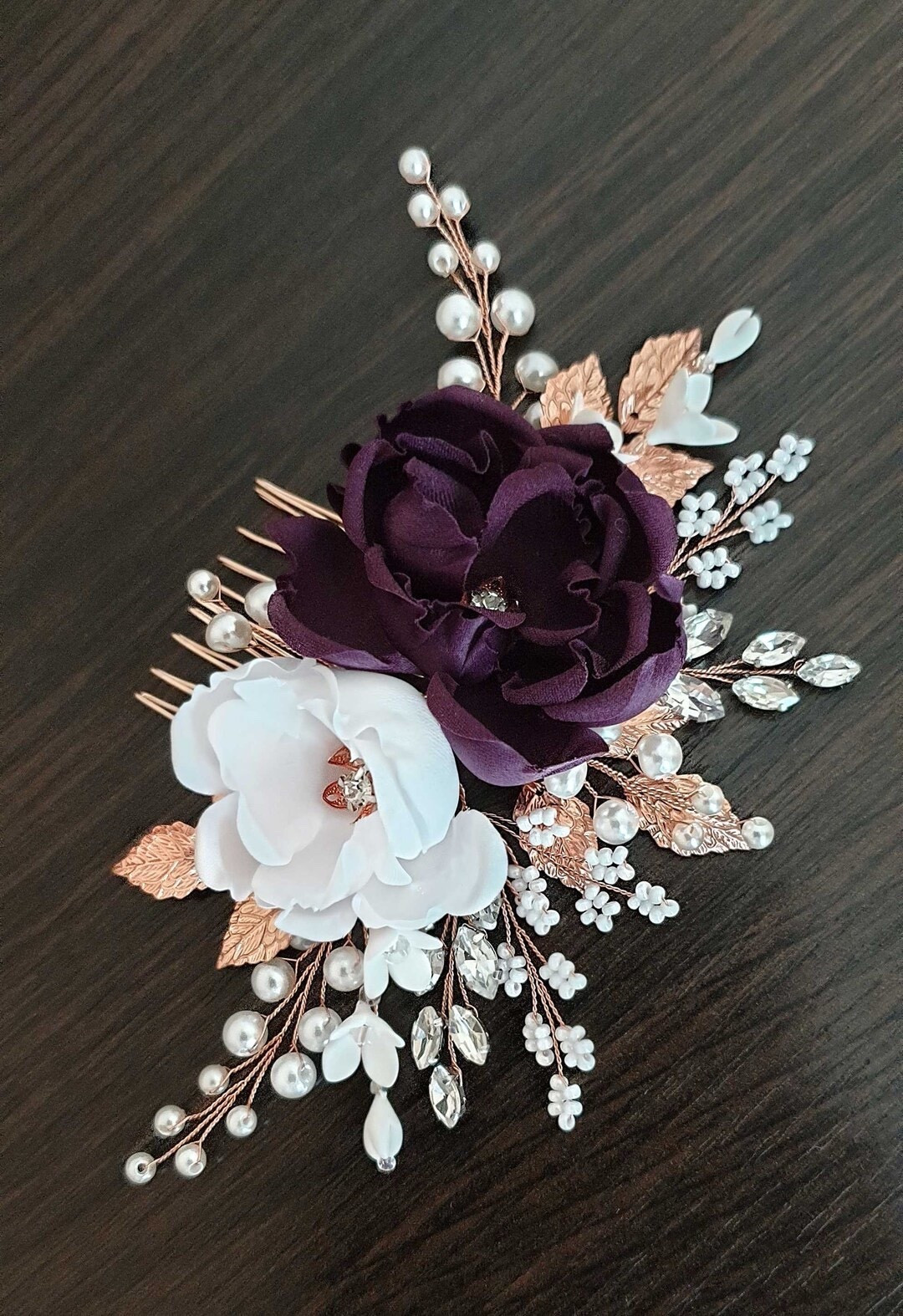 Add a soft pop of color to your bridal look with this purple silk flower hair comb set on a beautiful rose gold base. Designed with delicate pearls, sparkling crystals, and handcrafted floral details, this lightweight piece brings elegant texture and shimmer to any hairstyle. Perfect for romantic weddings, it pairs beautifully with loose curls, braids, or classic updos—and can easily coordinate with matching bridesmaid accessories. #bridalhair #purplewedding #rosegoldwedding #bridalaccessories #weddingstyle #ltkbride #weddinginspiration

#LTKWedding #LTKSeasonal #LTKSpringSale