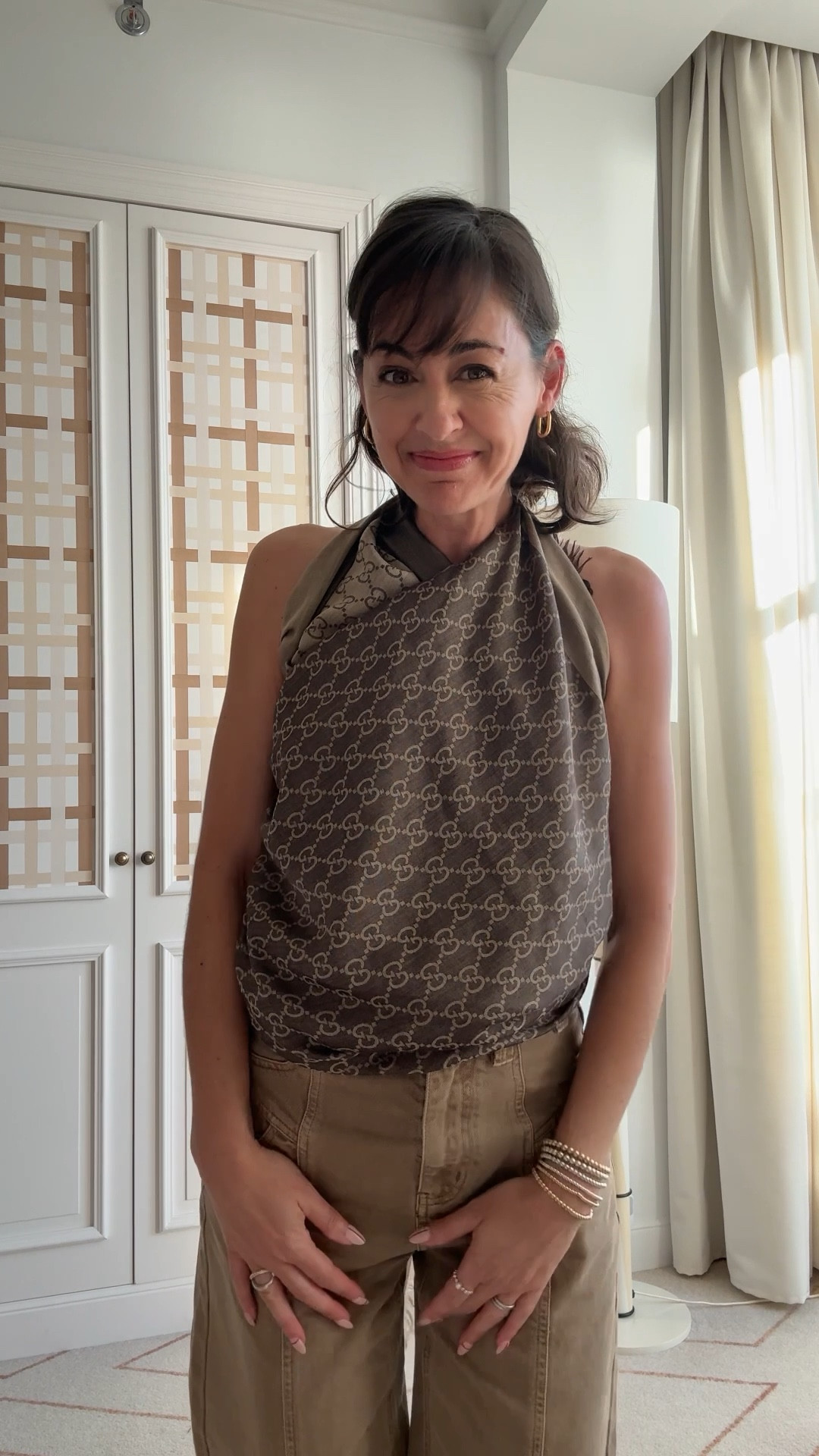 This is why I always travel with a large scarf. They work well to accessorize a cold weather travel outfit or make a new one for warm weather.

Save this post with directions on how to tie a scarf. 

1. Start with a large square scarf (mine is approx 52” wide) and fold it  into a triangle
3. Tie in a knot around your waist with point facing down.
3. Separate the two pieces from the point and bring one piece up over each shoulder to tie around your neck.
4. Any extra fabric in the back can be tied around your bra or brought back to the front and tied at your waist. 



#LTKTravel