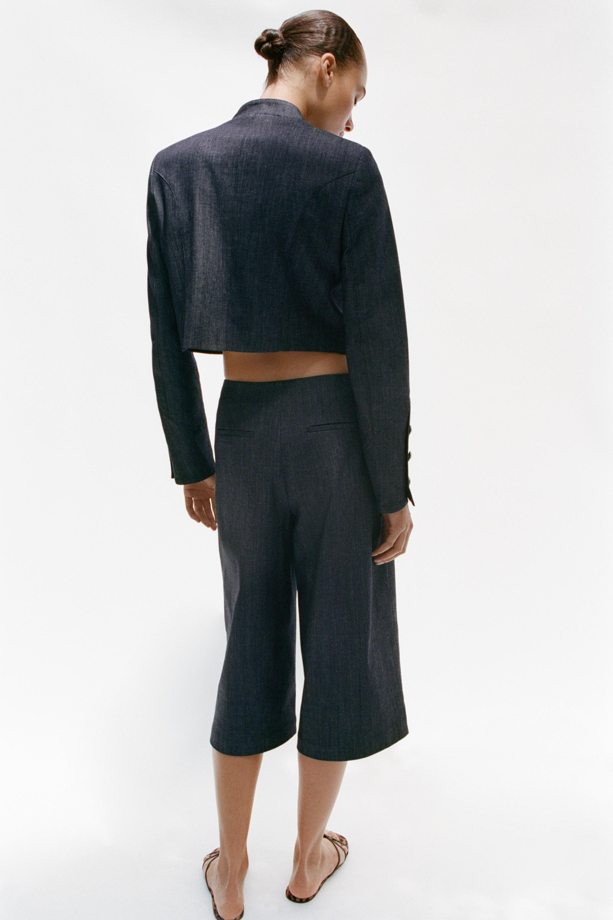Cropped jacket featuring a stand collar, long sleeves with shoulder pads, and button cuffs. Detai... | Zara US