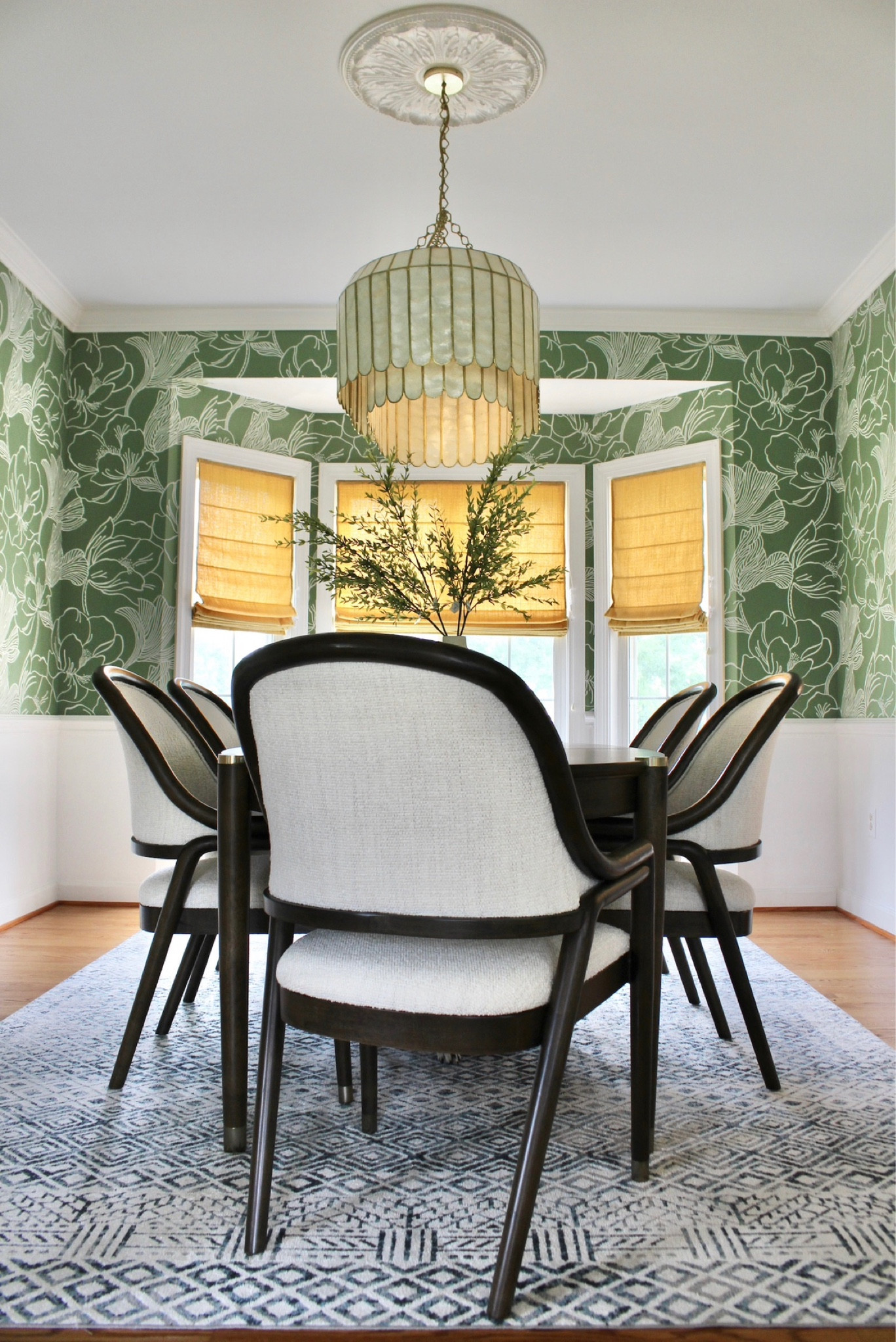 Fun, green dining room with floral wallpaper, capiz chandelier, patterned area rug, and an expandable dining table.

Dining room table, dining room rug, colorful room, home decor, Shannon Russo Interiors

#LTKhome #LTKunder100 #LTKFind