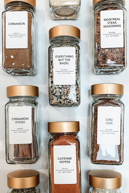 Spice rack organization with gold lidded glass spice jars and simple labels

#LTKunder50 #LTKhome
