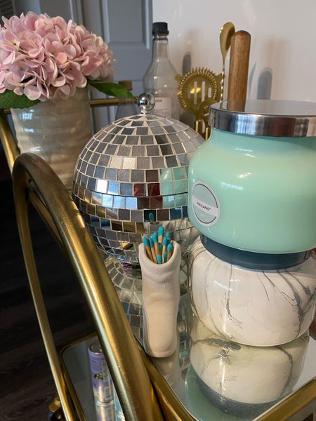 Disco ice bucket and aesthetic volcano candles on a gold bar cart. 

#LTKhome #LTKfindsunder100 #LTKfindsunder50