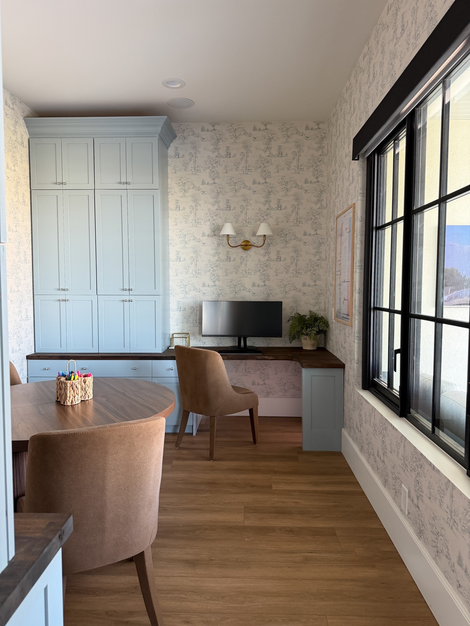 Office/Craft Room Budget Breakdown ⬇️
A friend told me they got a bid the other day for a similar office configuration and it was going to be $15,000! 😬
This room is living proof that you can have a whole room with a LOT of storage for not even 1/3 of the cost if you are willing to do some of the work yourself.

Door materials $230
Paint $124
Butcher Block $738
Wallpaper - gifted 
Light $160
Knobs $138
Hinges $80
Cabinet boxes $1800
Crown & Trim	$200
	Total: $3470

Paint color: @sherwinwilliams Stardew
Wallpaper @sandbergwallpaper Montfort Indigo Blue
Desktop stain: @minwaxusa Dark Walnut