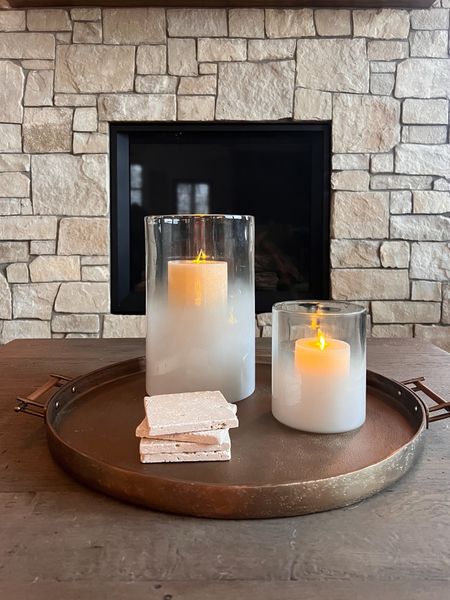Coffee table styling with a round tray and some flameless flicker candles! We always have a set of coasters around for beverages. 

Pottery barn, brass tray, rustic modern home decor, 

#LTKhome #LTKstyletip #LTKfindsunder100