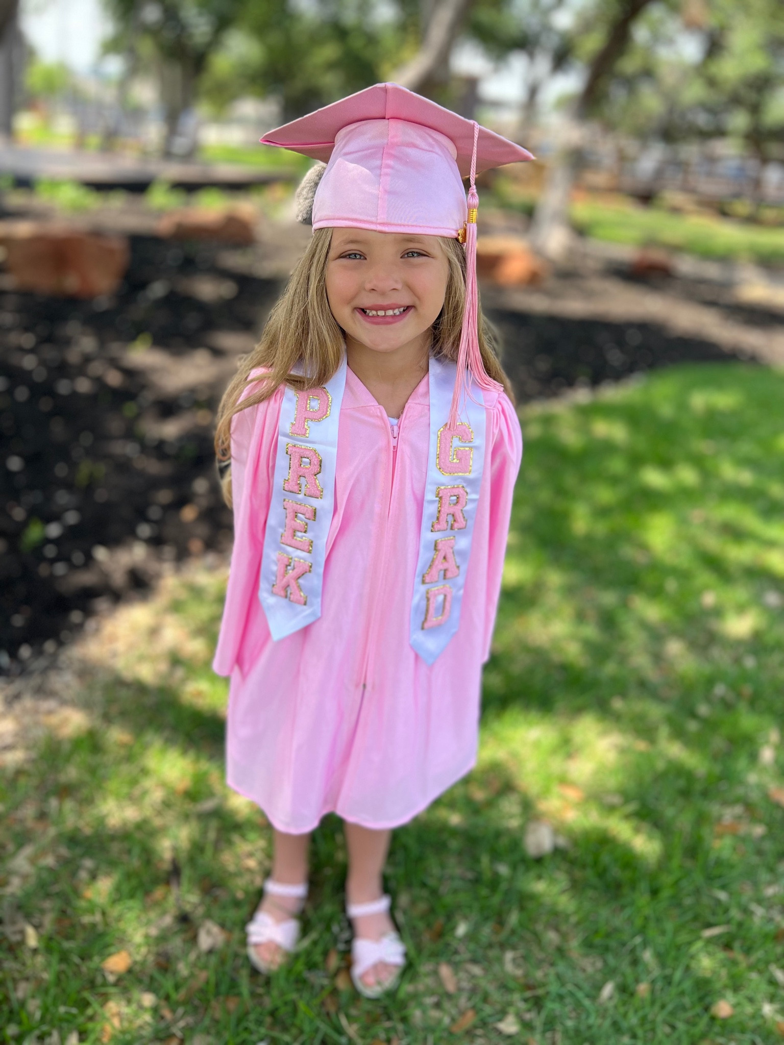 pretty in pink for my little girls preschool graduation! this cap and gown was the perfect size 

#graduation 
#summer
#preschool
#schooloutfit 
#gradgifts #graduationgift
#pinkdress #whitedress #sandals #pinkgingham #varsityletters #chenilleletters #stoneycloverdupe 

#LTKSeasonal #LTKkids #LTKfamily