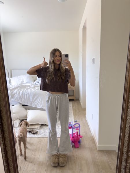casual at home loungewear outfit! 🤎 one of my favorite cropped T shirts 👏🏽 wearing a small! these pants are Abercrombie but sold out so I linked a similar! These ugg slippers are also sold out so linked a similar! I think I like the similar pair I linked more too haha the ones I have is way too high of a heel. The ones I linked are flat and look comfier! 