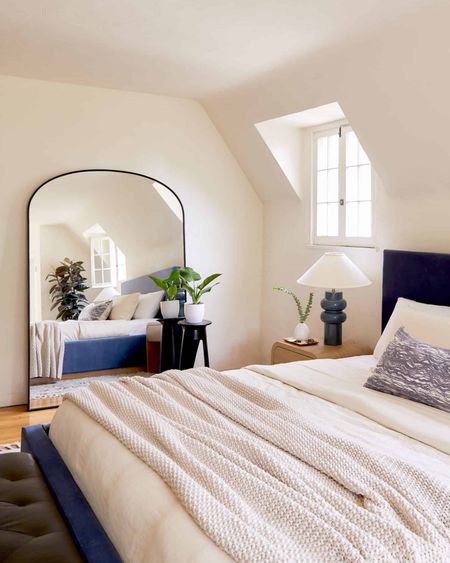The original plan for this bedroom involved a dark limewash paint…until the client (one of my best friends) revealed that she wanted the space to feel like a “warm hug.” We kept her warm white walls, added a timeless velvet bed, pulled some modern nightstands (the tone speaks to the base of the bedframe!), brought in a huge mirror to bounce light around (also for outfit checks - she’s a fashion pro!), and layered in texture and life with these cozy linens, graphic drink table, and a few pieces of greenery. SUMMER SANCTUARY ACHIEVED. 

#LTKSeasonal #LTKhome #LTKfamily