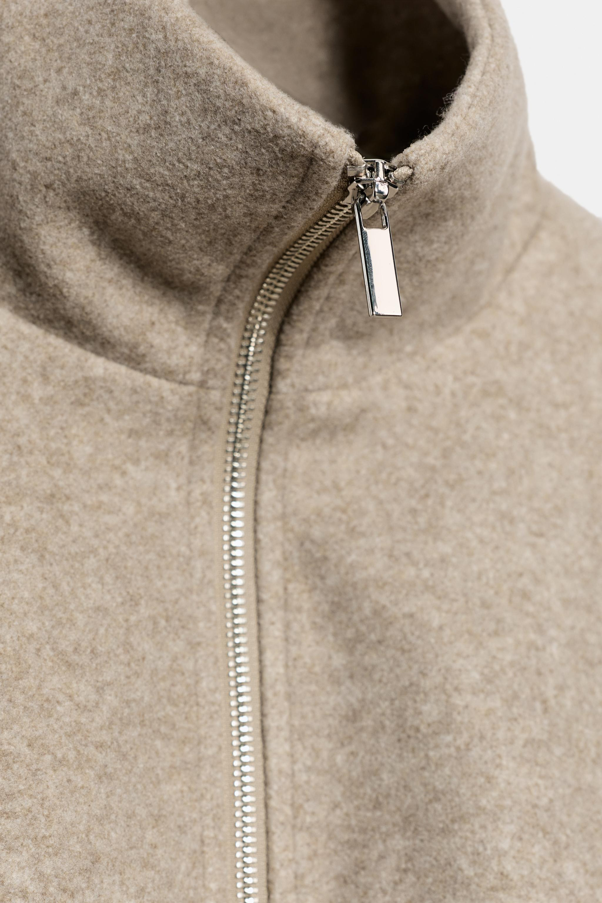 Bomber jacket with a high collar and long sleeves. Featuring double welt front pockets, gathered ... | Zara UK