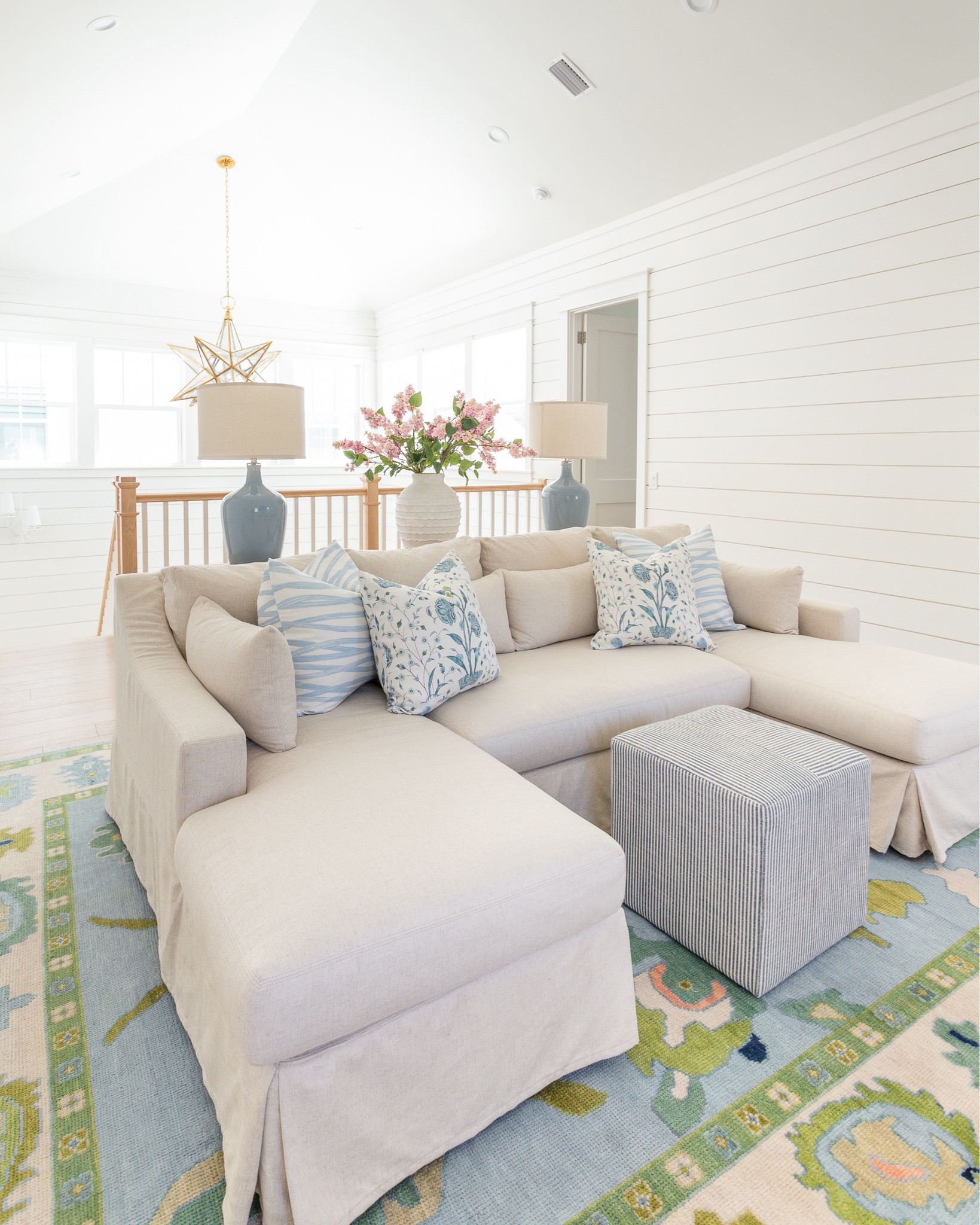 Our loft living room decorated for spring! I used these pink lilac stems, ribbed white vase, colorful oushak rug, linen sectional, light wood console table, blue lamps, striped ottoman cube, brushstroke throw pillow and floral pillow for pops of spring. See our full spring home tour here: https://lifeonvirginiastreet.com/2024-spring-home-tour/
.
#ltkhome #ltksalealert #ltkfindsunder50 #ltkfindsunder100 #ltkstyletip #ltkseasonal spring living room, sectional styling, colorful spring decor

#LTKsalealert #LTKhome #LTKSeasonal