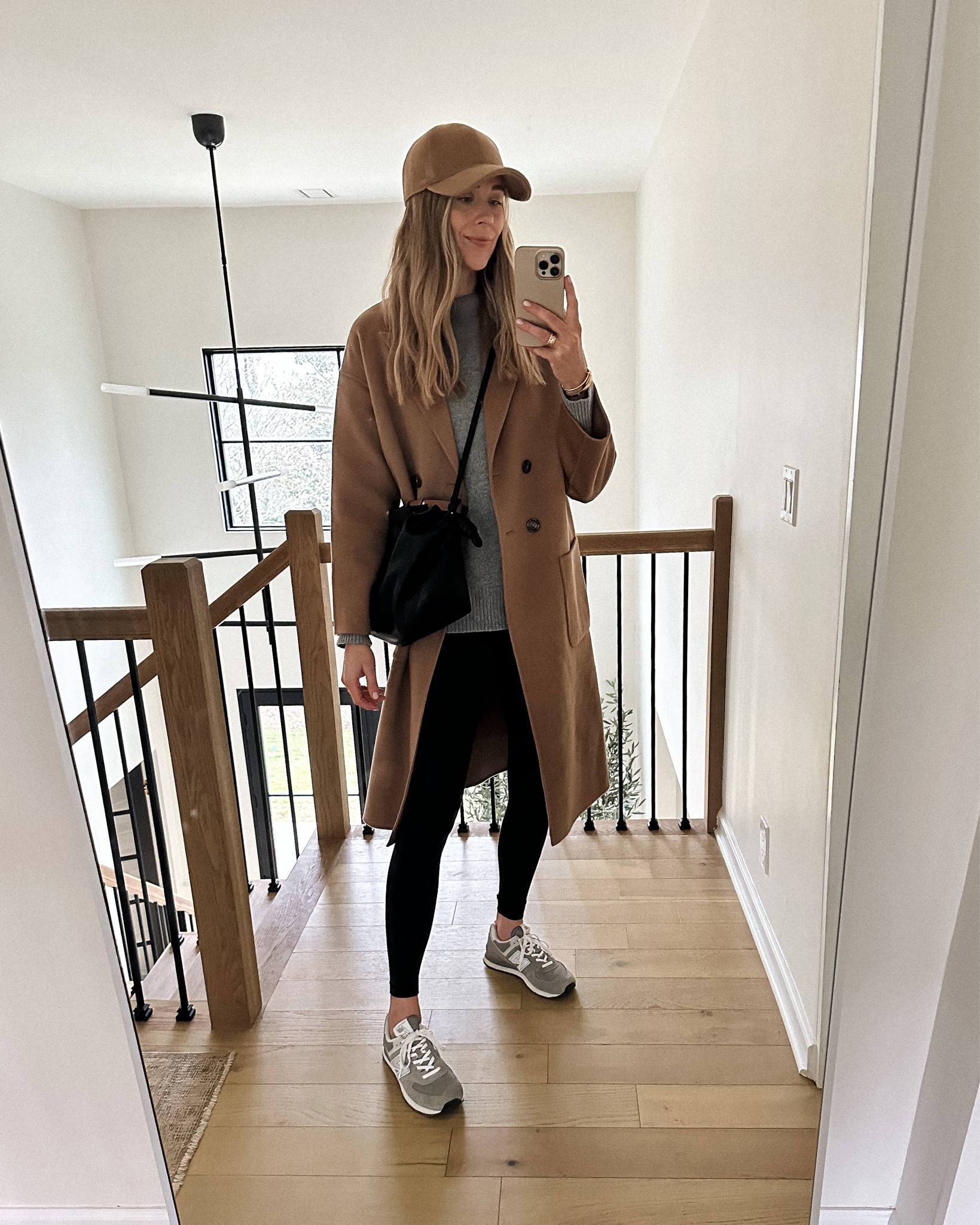Fashion Jackson wearing Anine Bing camel coat (xs) grey sweater (small), lululemon black leggings (size 4) new balance sneakers, Totême baseball hat, Loewe handbag #winteroutfit #athleisure #fashionjackson 

#LTKtravel #LTKunder100 #LTKshoecrush