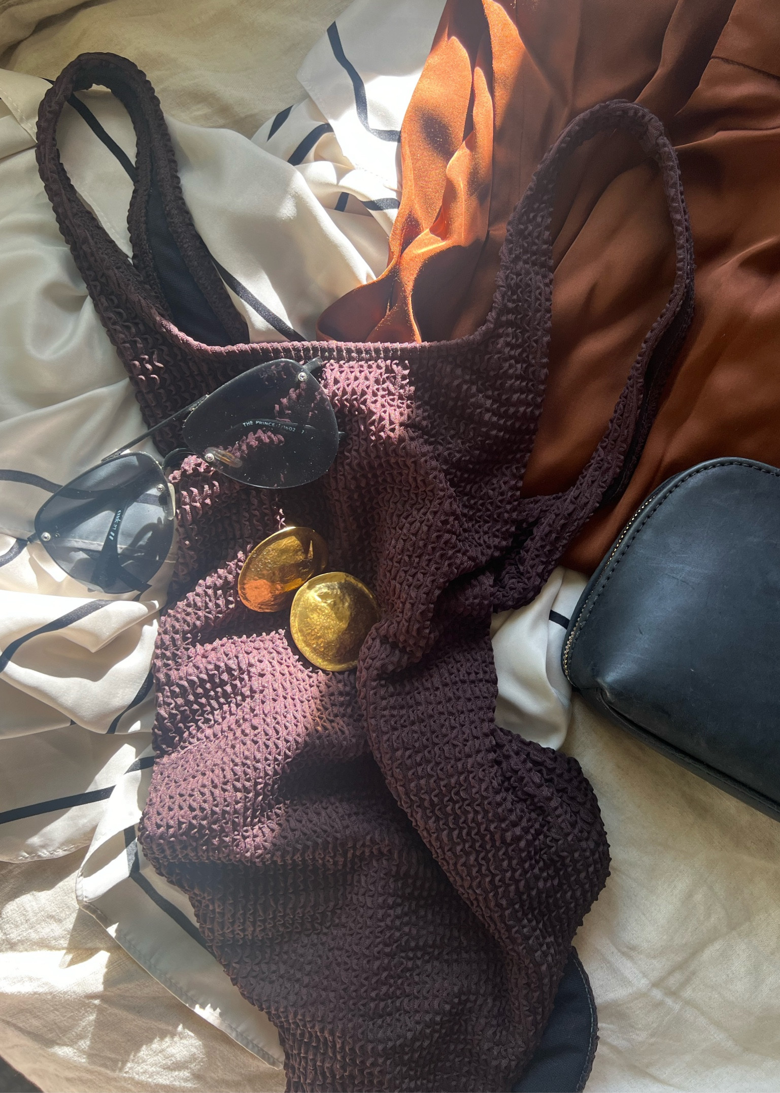 Resort ware packing and dark brown one piece swimsuit 

#LTKswim #LTKfindsunder50