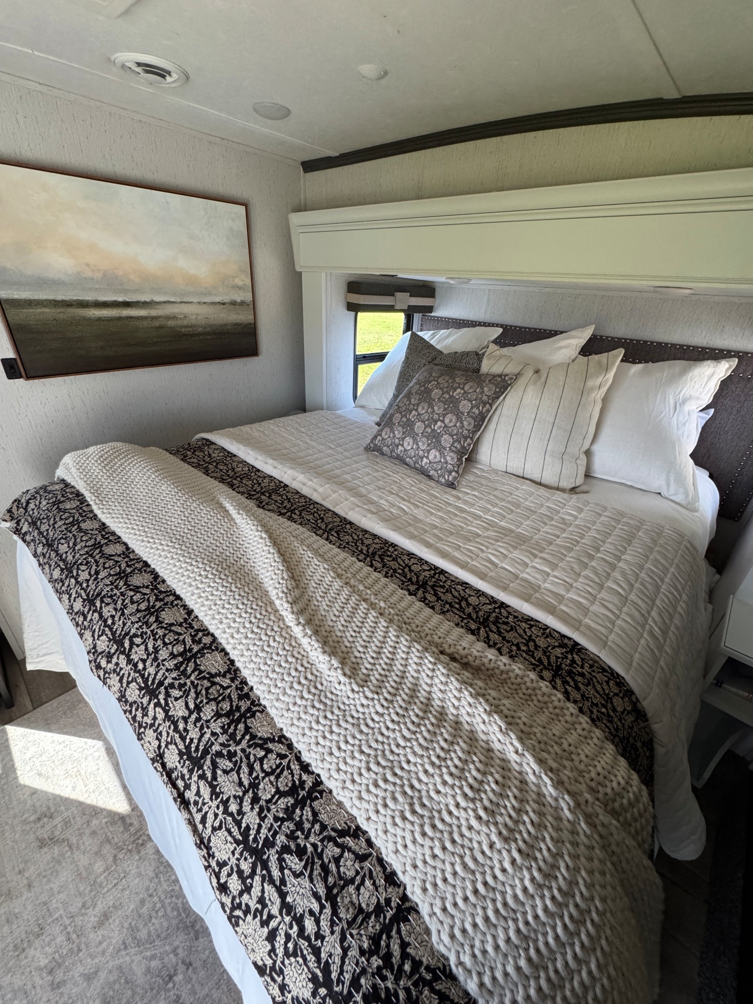 Camper bedroom but make it cute 🤍 Kept things super simple with cozy textures, soft neutrals, and pieces that don’t take up much space! #LTKhome #camperlife #neutralbedroom #tinyhomevibes
