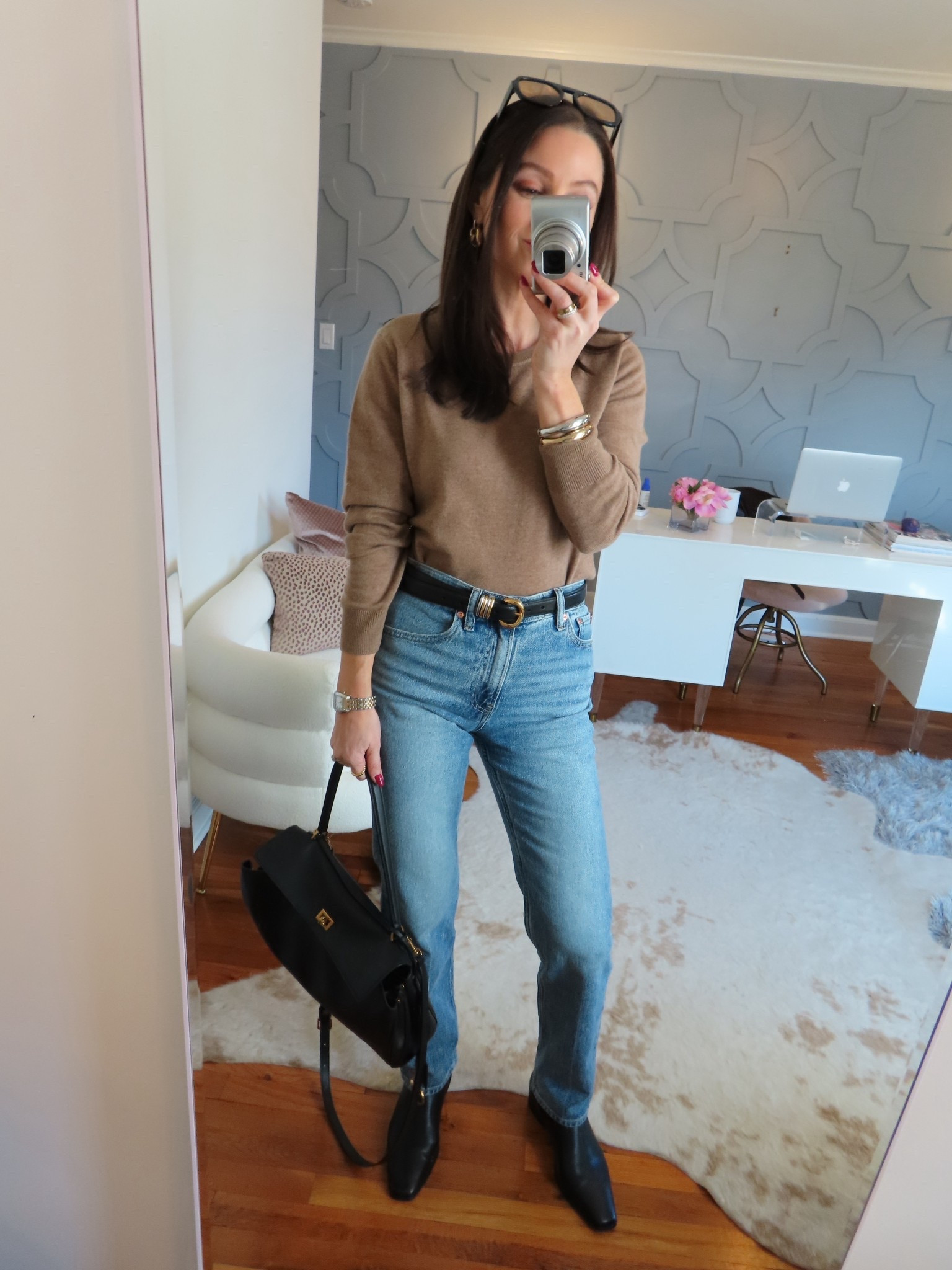 True to size in sweater and jeans. Sized up a half a size in the boots