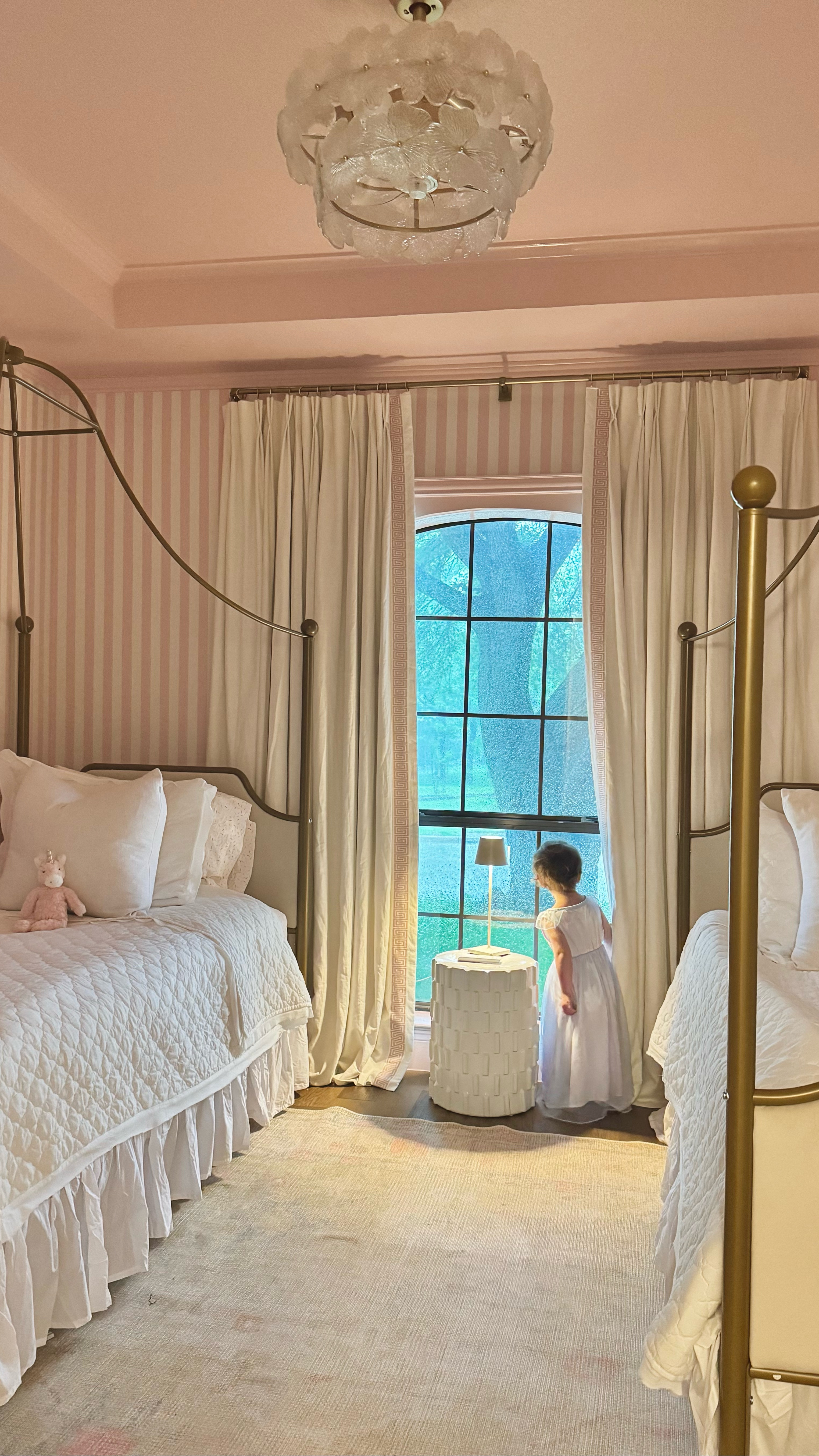 Another personal project for us tackled (almost). After being in the house for sometime, we decided that this room was not best utilized as the playroom for our girls and should be there shared bedroom. This was our first time to work with trim, molding, and painting like we did. I didn’t want to spend the money on wallpaper as I knew that the girls would play pretty hard in this room and wanted something durable and budget friendly for us. I decided on trimming out the room, including the window to dress it up before making the upper half look like striped pink wallpaper. It was a serious labor of love, but I would do it again because it looks so perfect and precious. I found these beds on Amazon and a Wayfair and snag them on a sale on Amazon and they really inspired the entire room. It was just the perfect Parisian princess vibe that made me pull it all together. I’m still on the hunt for a nightstand so I have a temporary accent table working with a cordless lamp for now. But just a few more final touches including the bedding and this room will be 100% perfect. You can shop my kid, friendly and budget friendly finds on my LTK app. These are seriously some good ones!

#interiordesigner #interiordesign #girlsbedroom #diy #homedecor #roomtransformation #ltkhome #bedroom #bedroomdesign